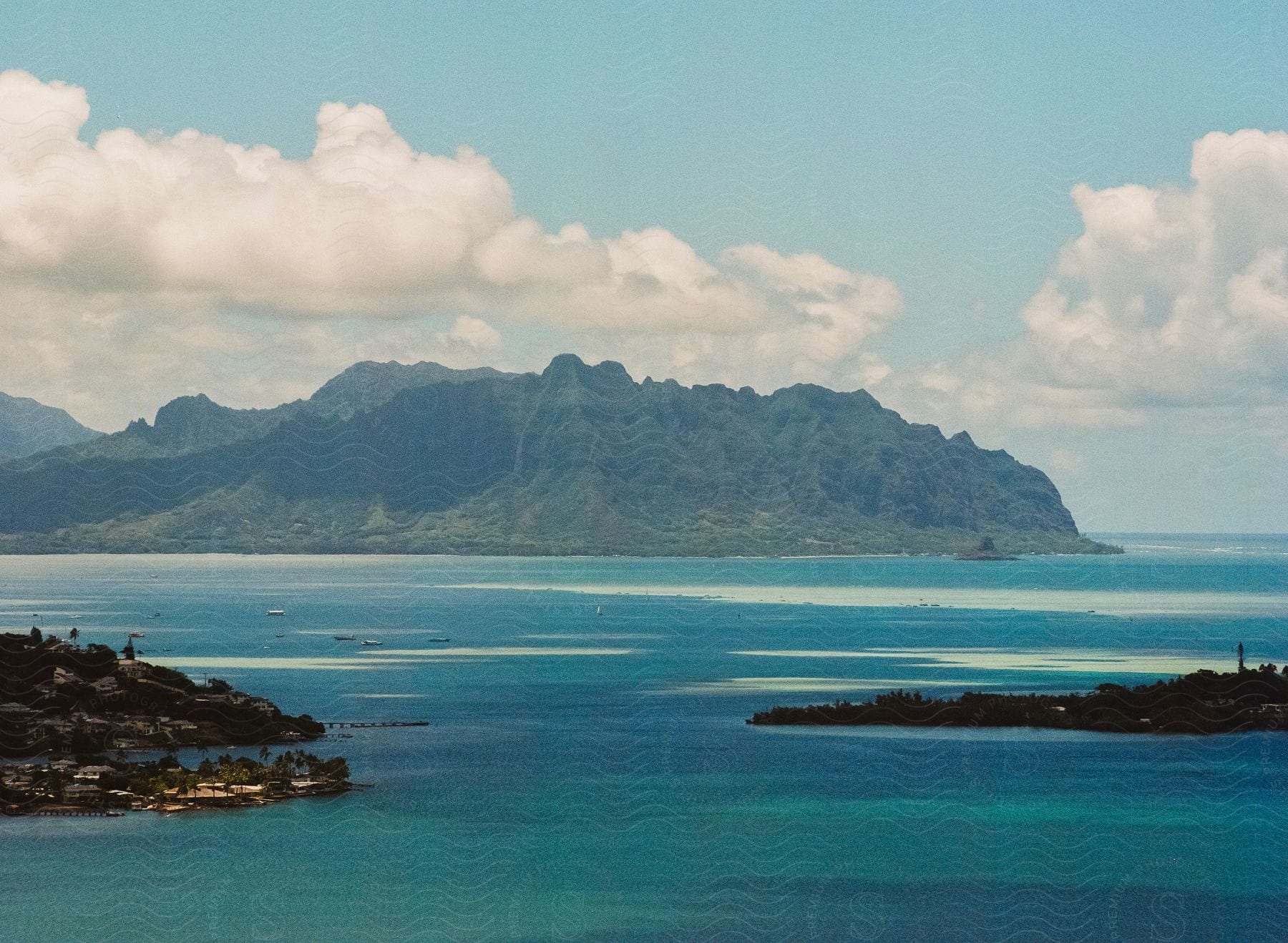 An island surrounded by the sea during the day.