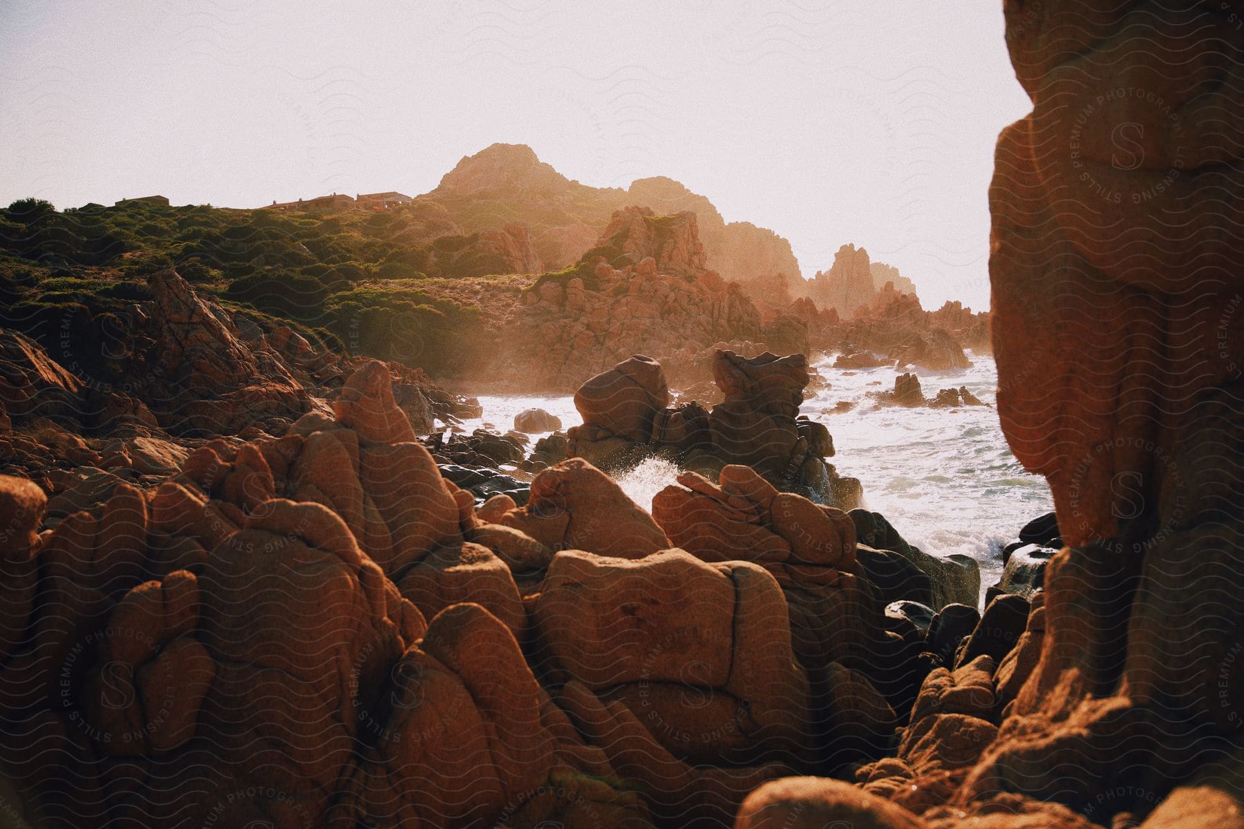 A view of the coast with rocks in the distance.