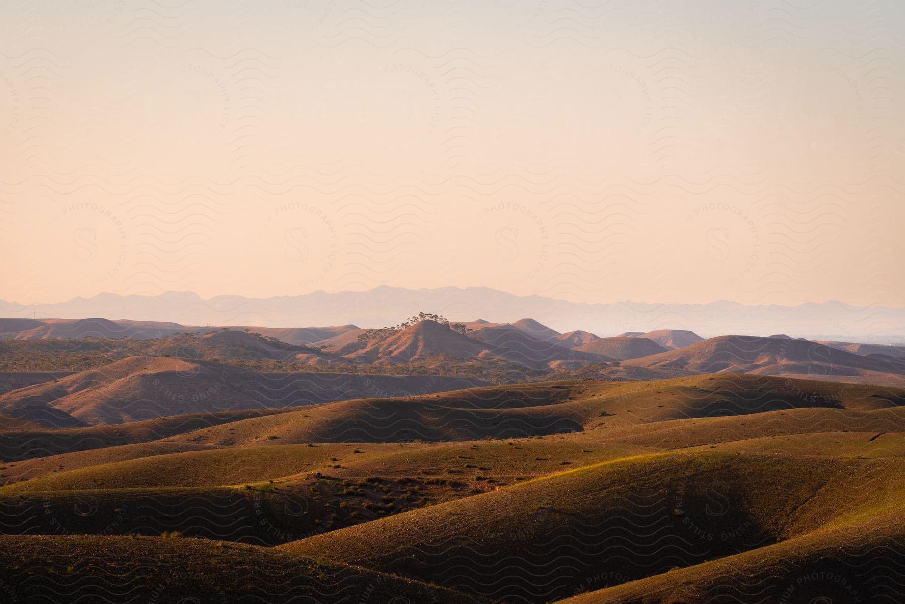 Landscape of mountains and plateaus on a morning with a red sky.