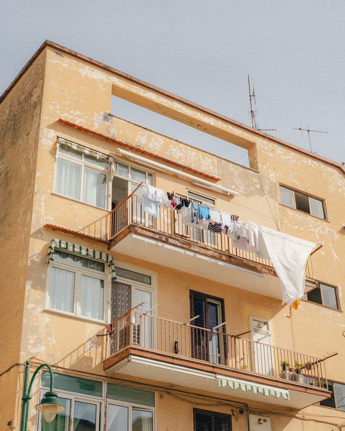 An apartment building with clothes hanging on a balcony