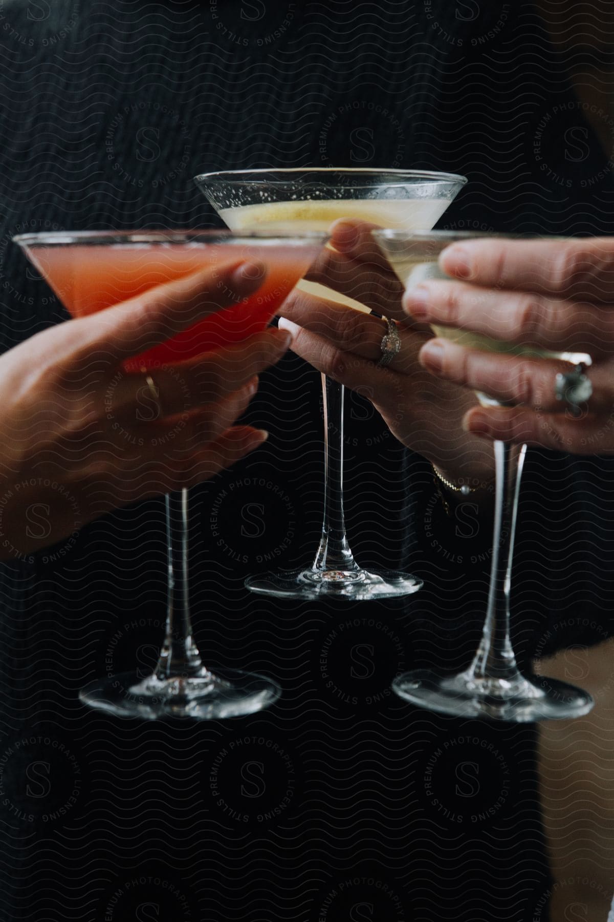 a group of women toasting cocktails