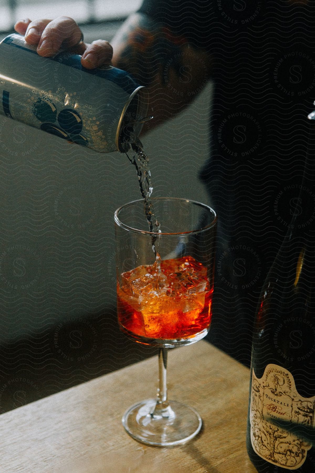 a man turning soda drink into a glass