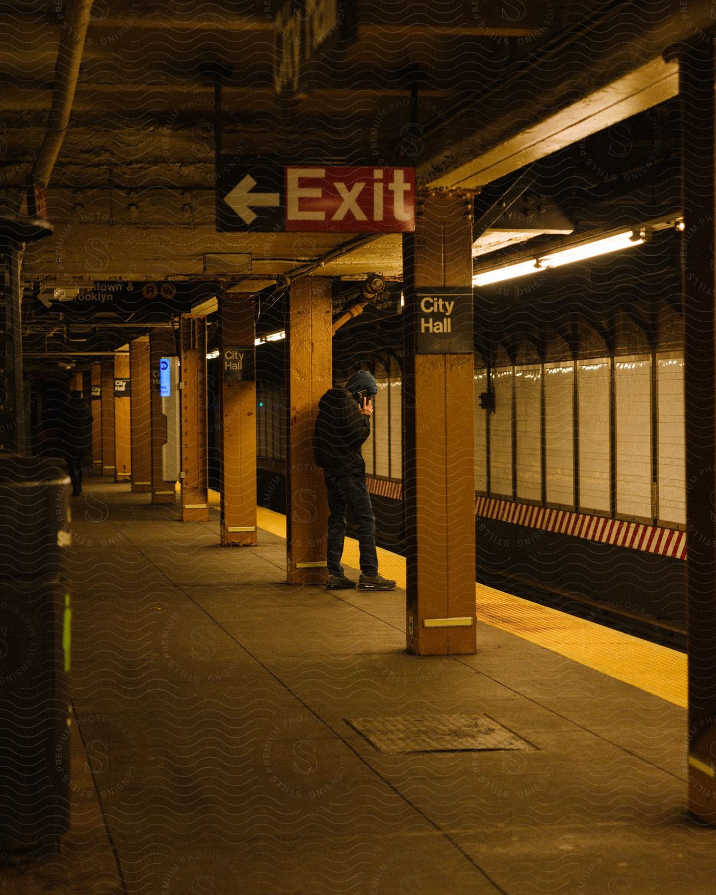 A man standing at a subway station