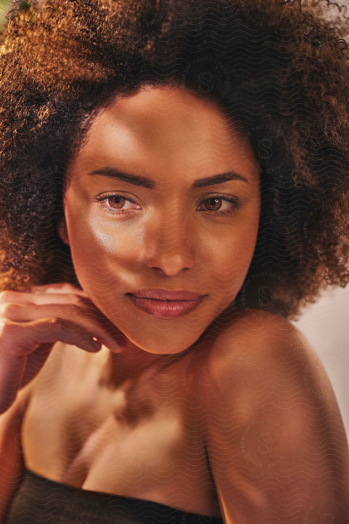 Sunlight shines on the face of a young woman as she looks ahead