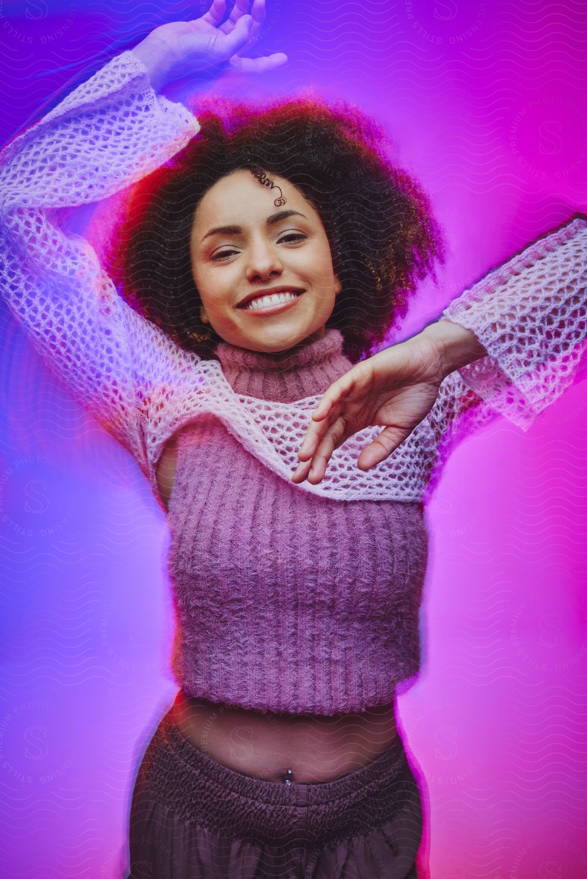 A portrait of a woman posing in a purple and blue studio