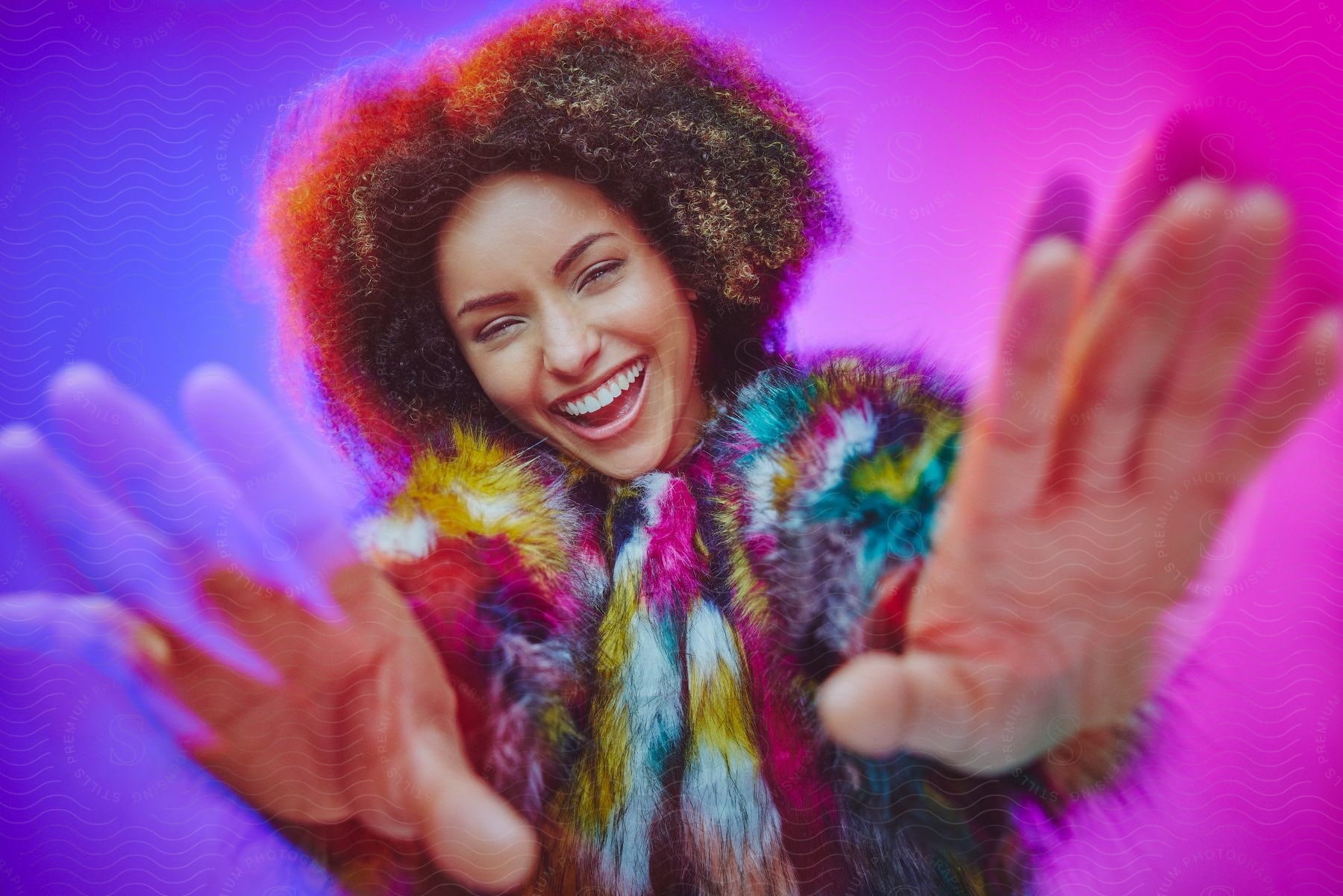 A curly-haired woman in a brightly colored fur coat.