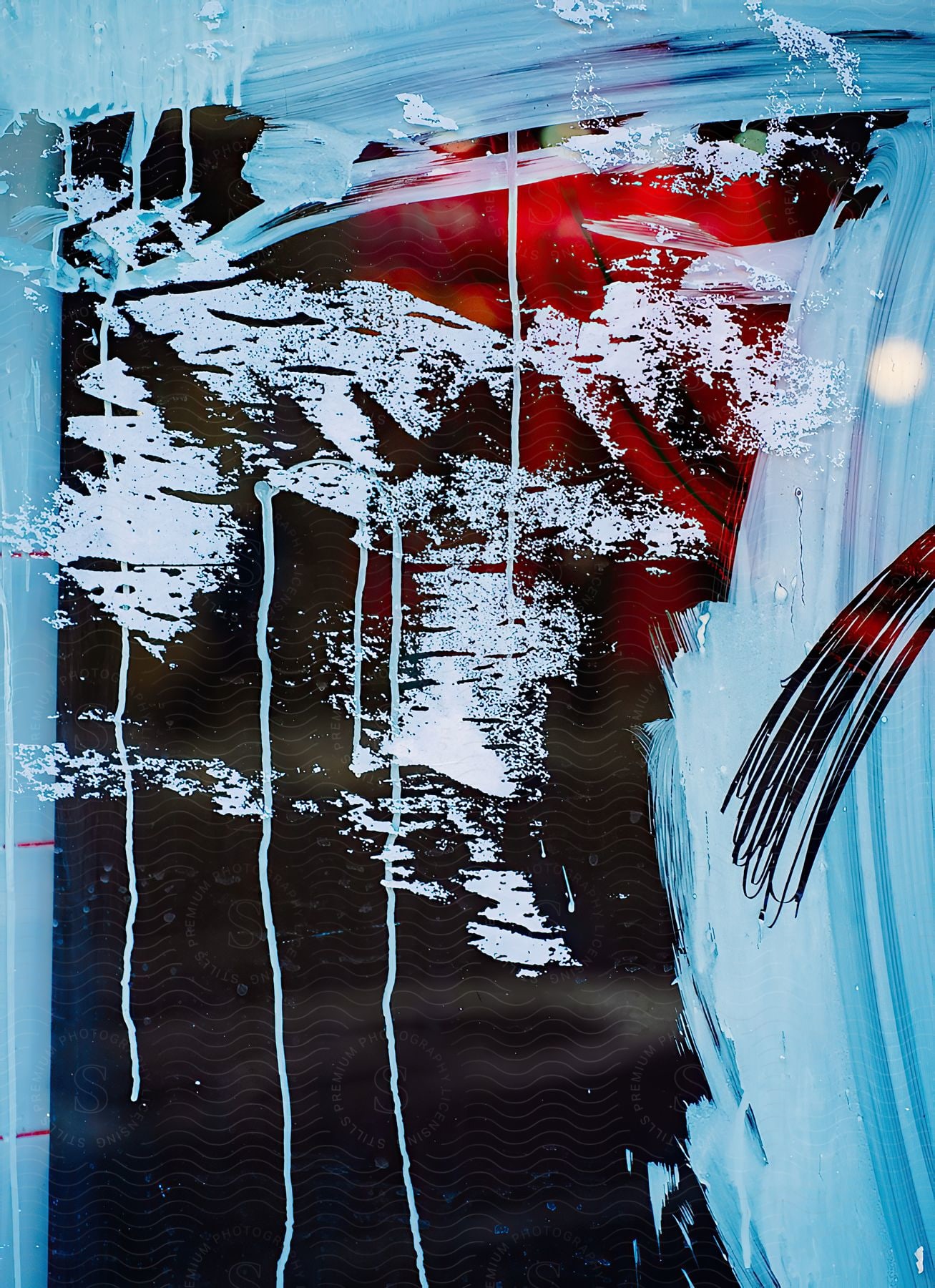 Scraped white streaks pierce a canvas splashed with red and black color