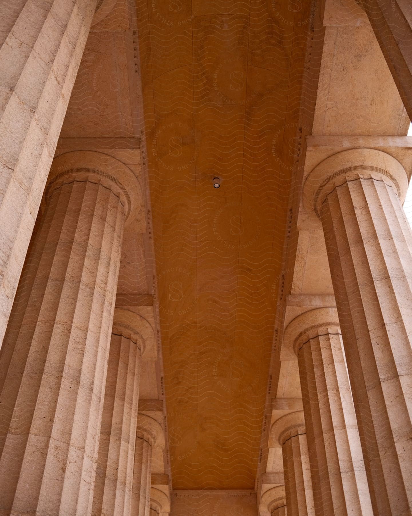 A concrete building contains large columns and a curved ceiling.