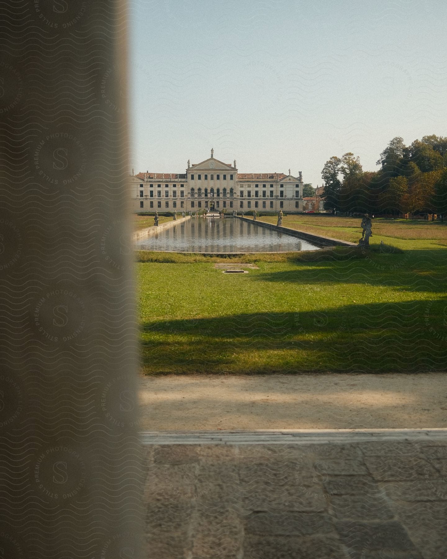 An Image Of A Building And A Lake Of The Lawn