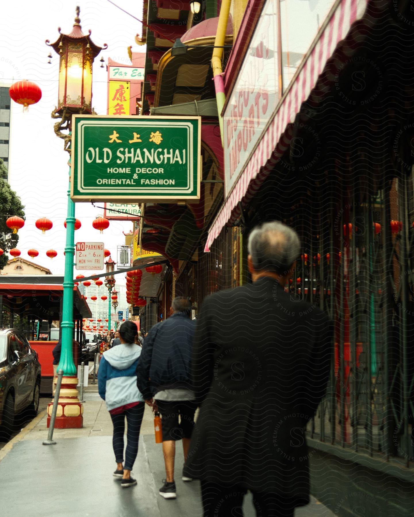 In Chinatown, a family strolls past a building labeled "Old Shanghai."
