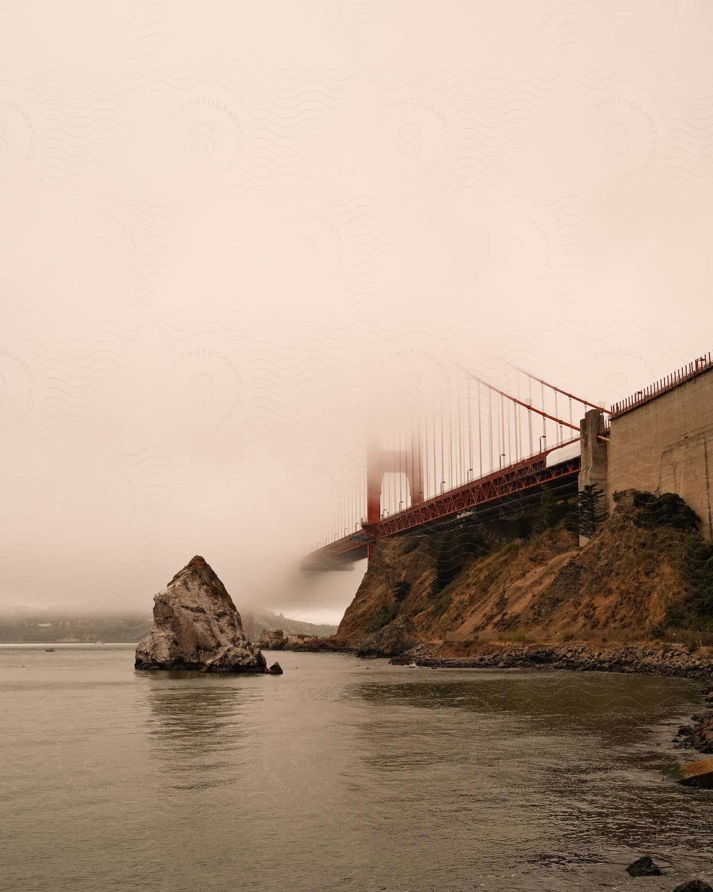 Landscape of a lake and the Golden Gate Bridge on a foggy day