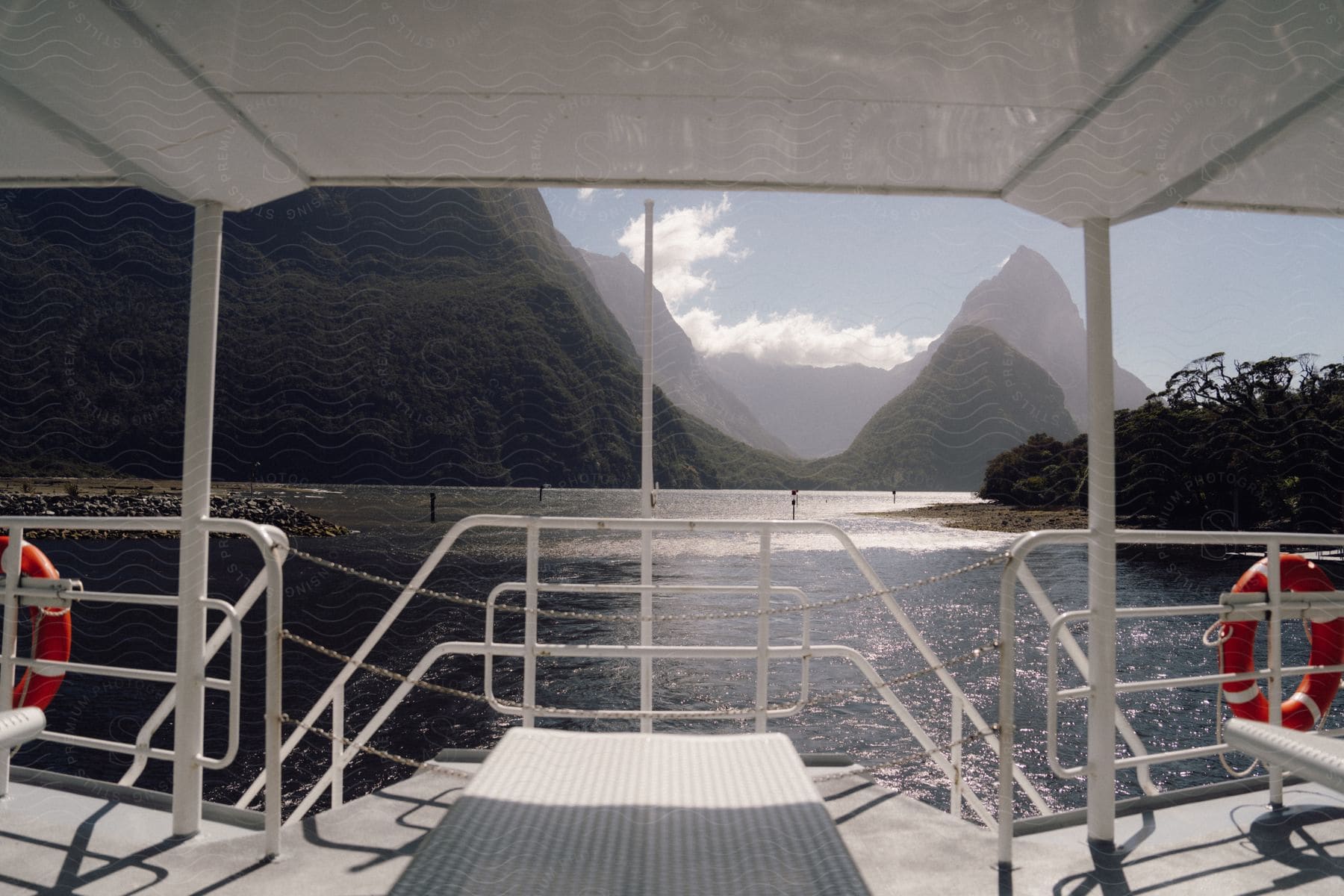 A boat sailing out on a lake on a sunny day