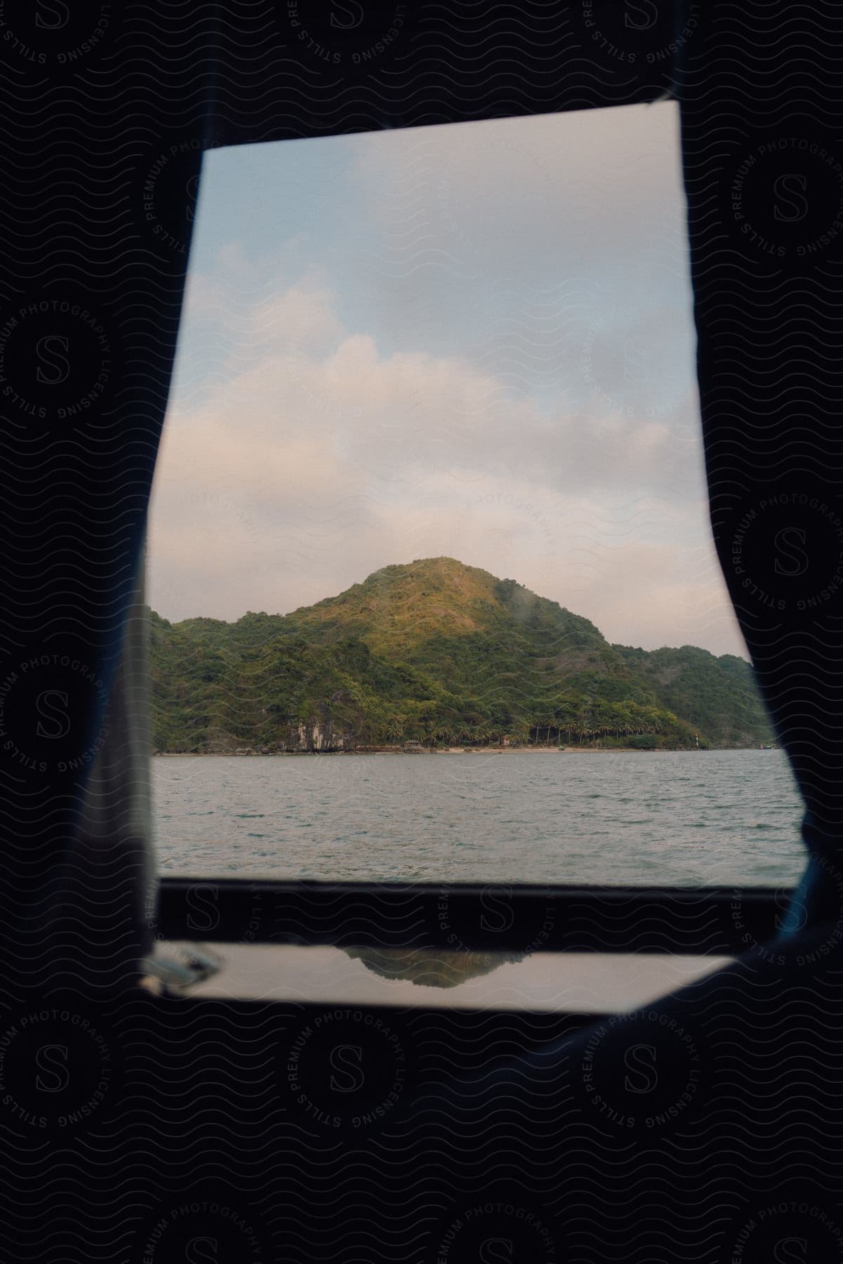 A mountain landscape seen through a window