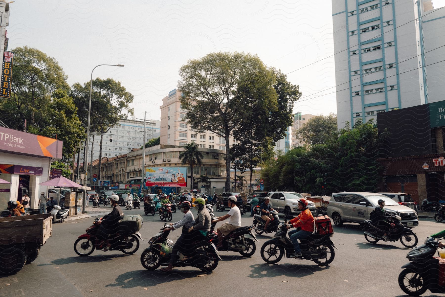 Intense city traffic, with a majority of motorcycles.