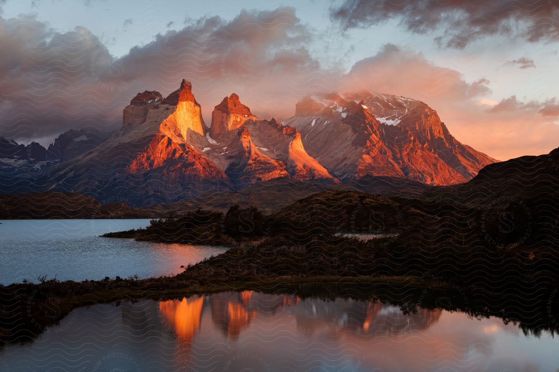 A view of a mountain range with clouds above it