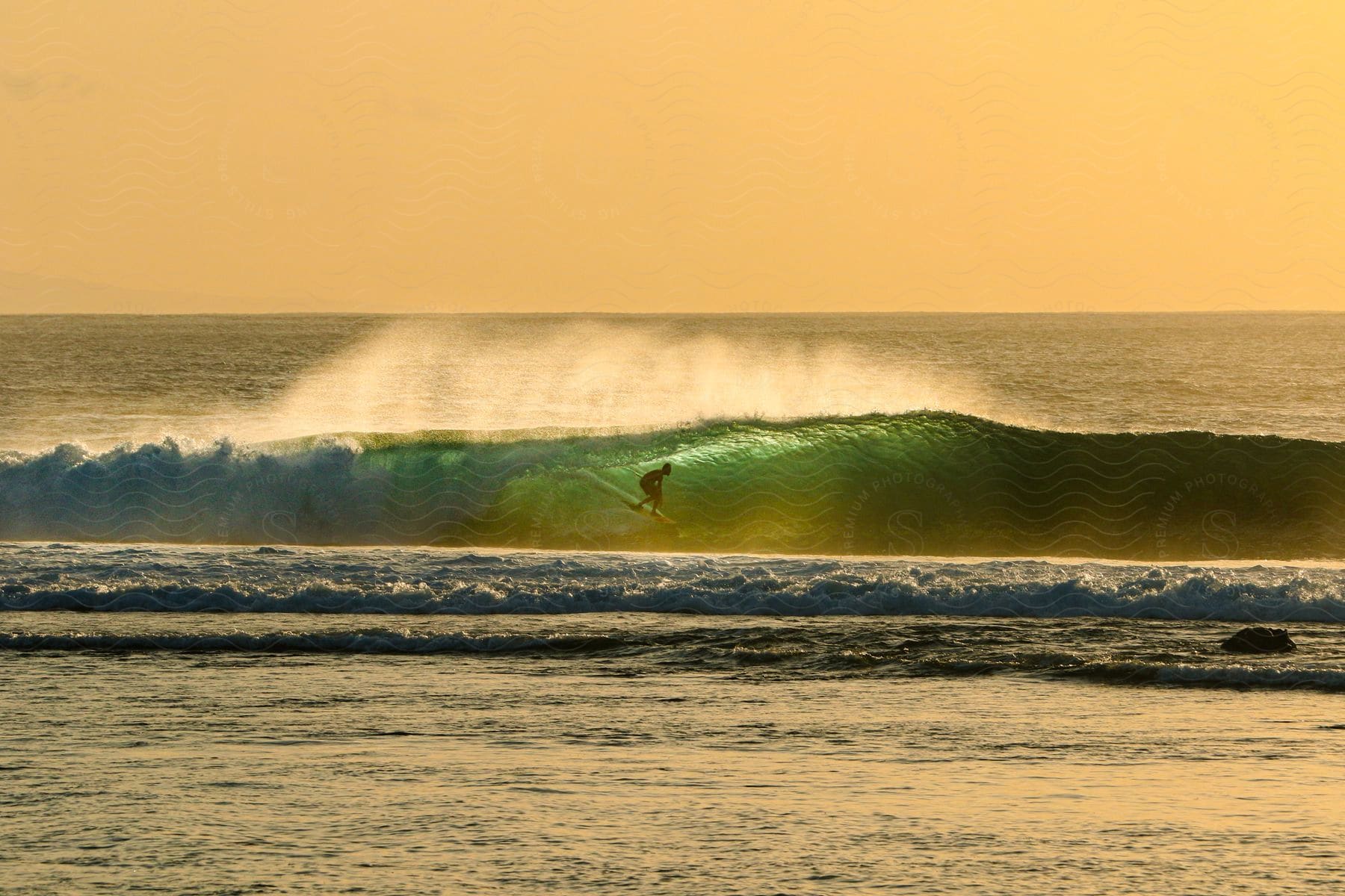 A person surfing on a large wave on the ocean