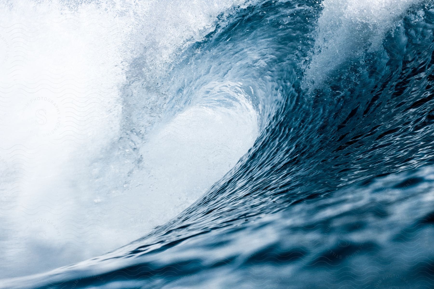 Close up of a large ocean wave curling and crashing in the ocean