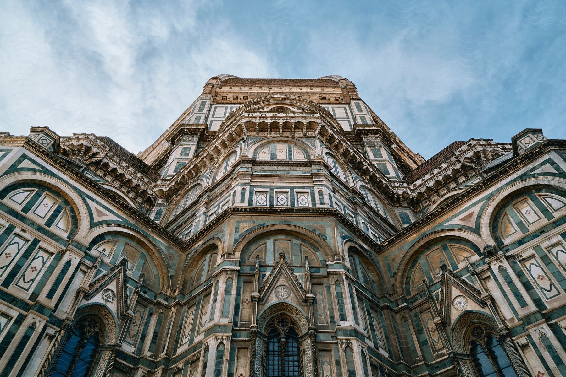 A tall tower with a lot of arches and decorations on it