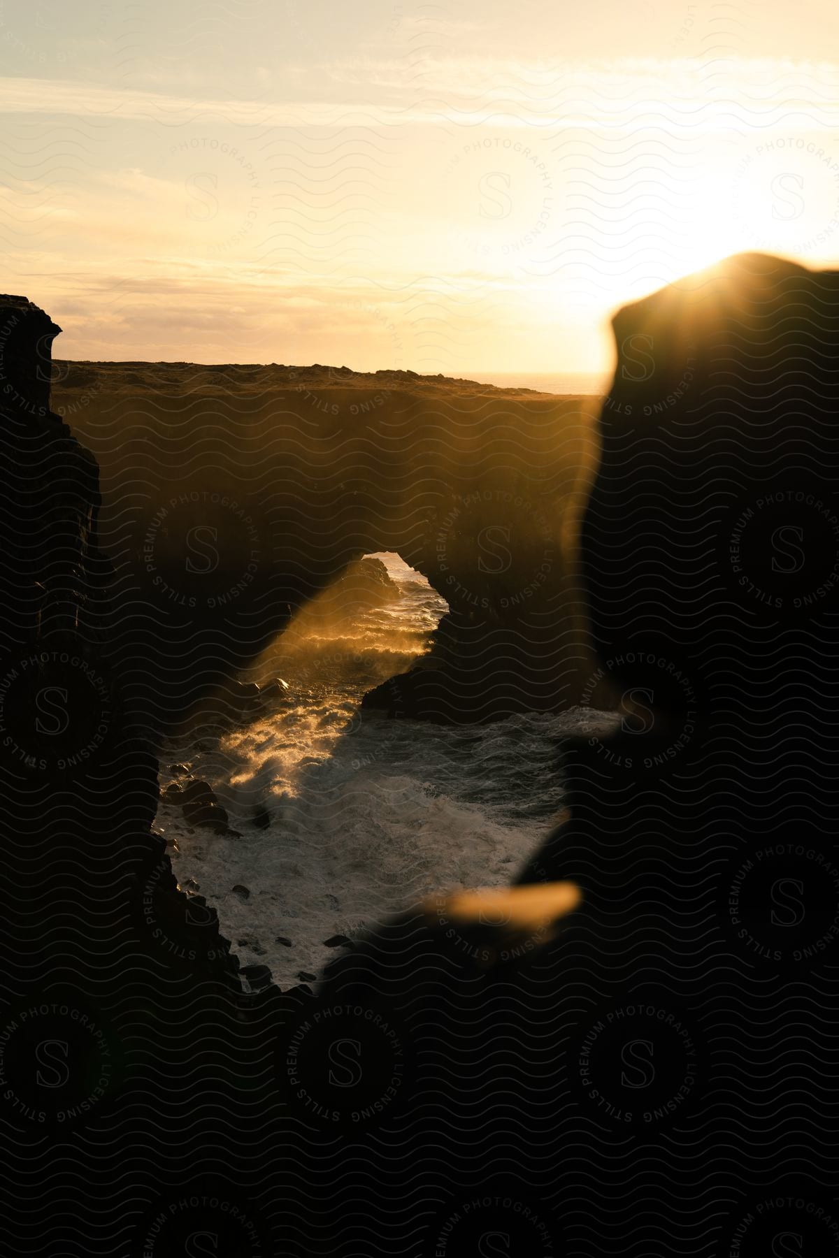 A rocky arch over an ocean inlet on the coast.