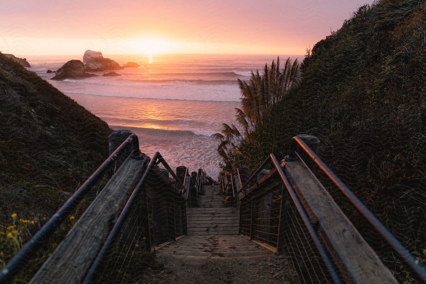 A breach and coast at the bottom of a long flight of stairs