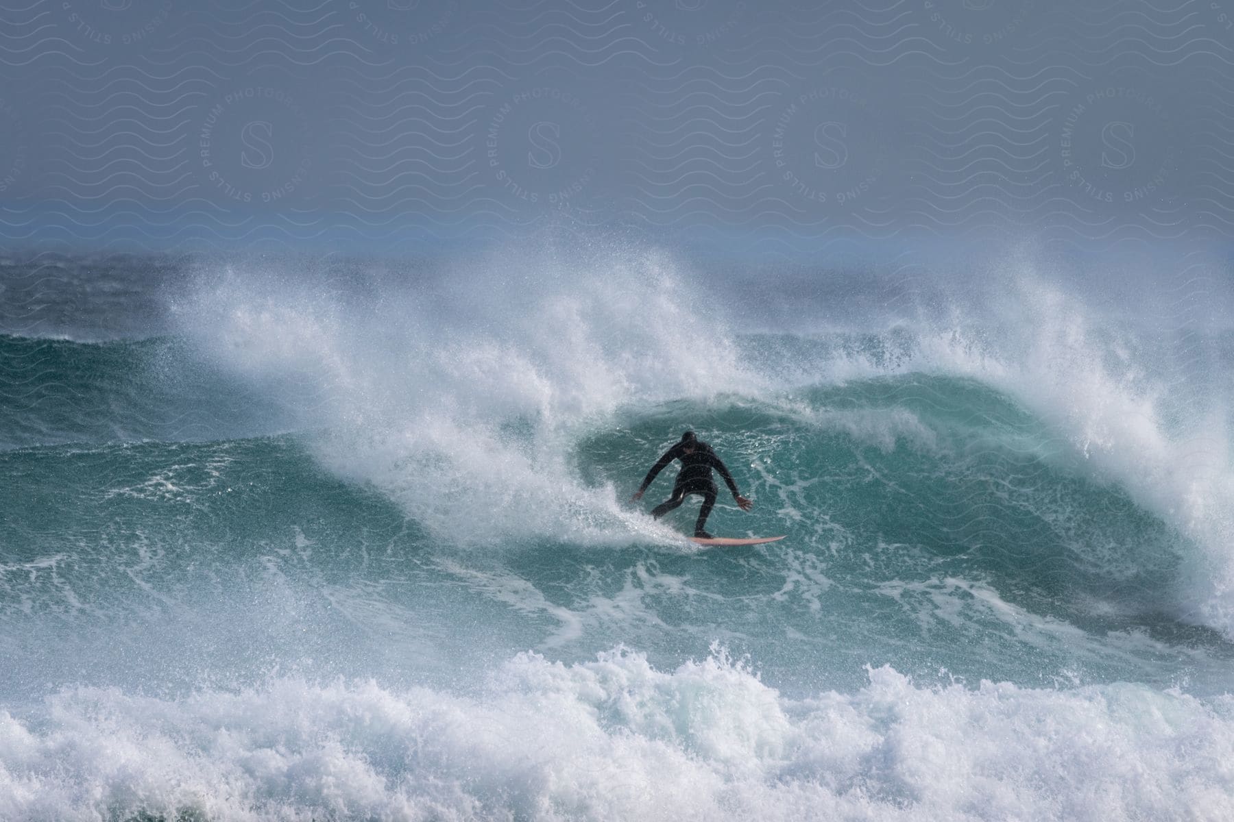 A skilled surfer on a surfboard, facing a big, powerful wave.