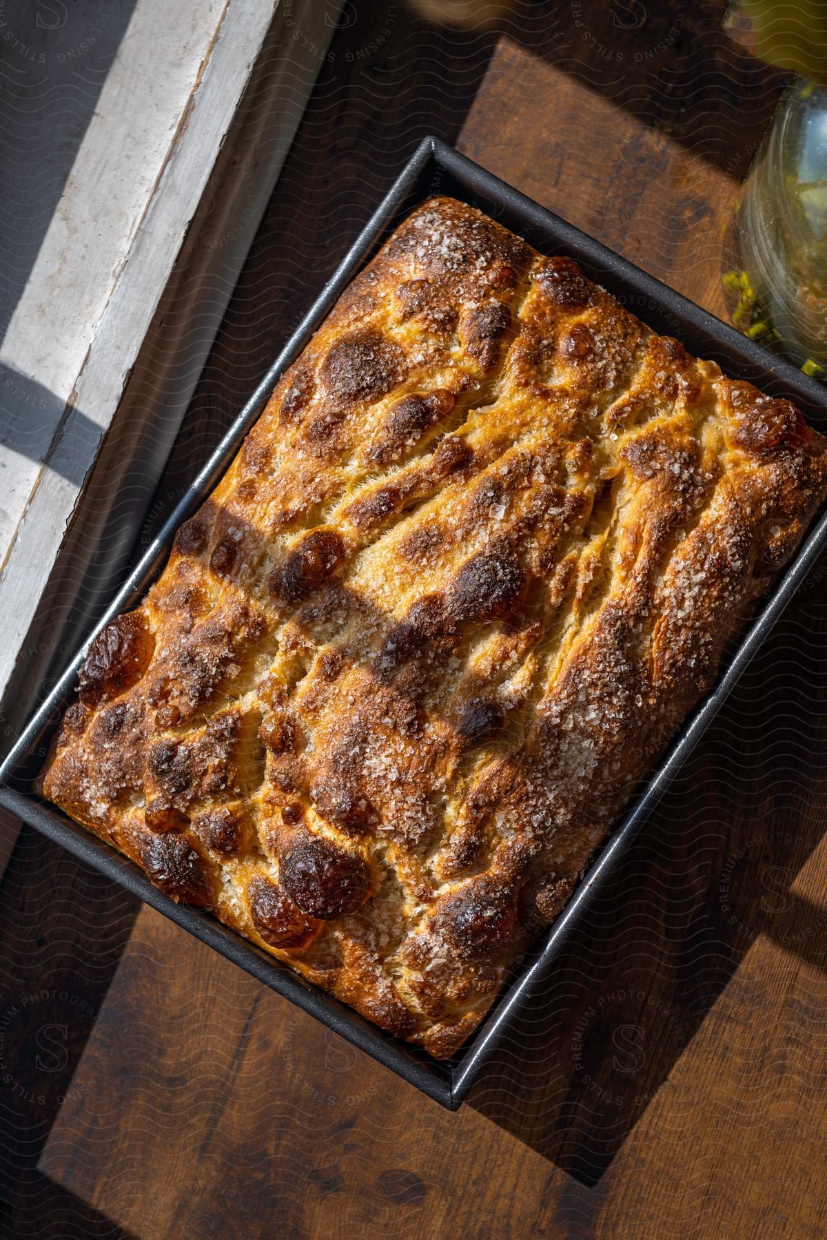 A pan that is full of bread sitting on a table cooling