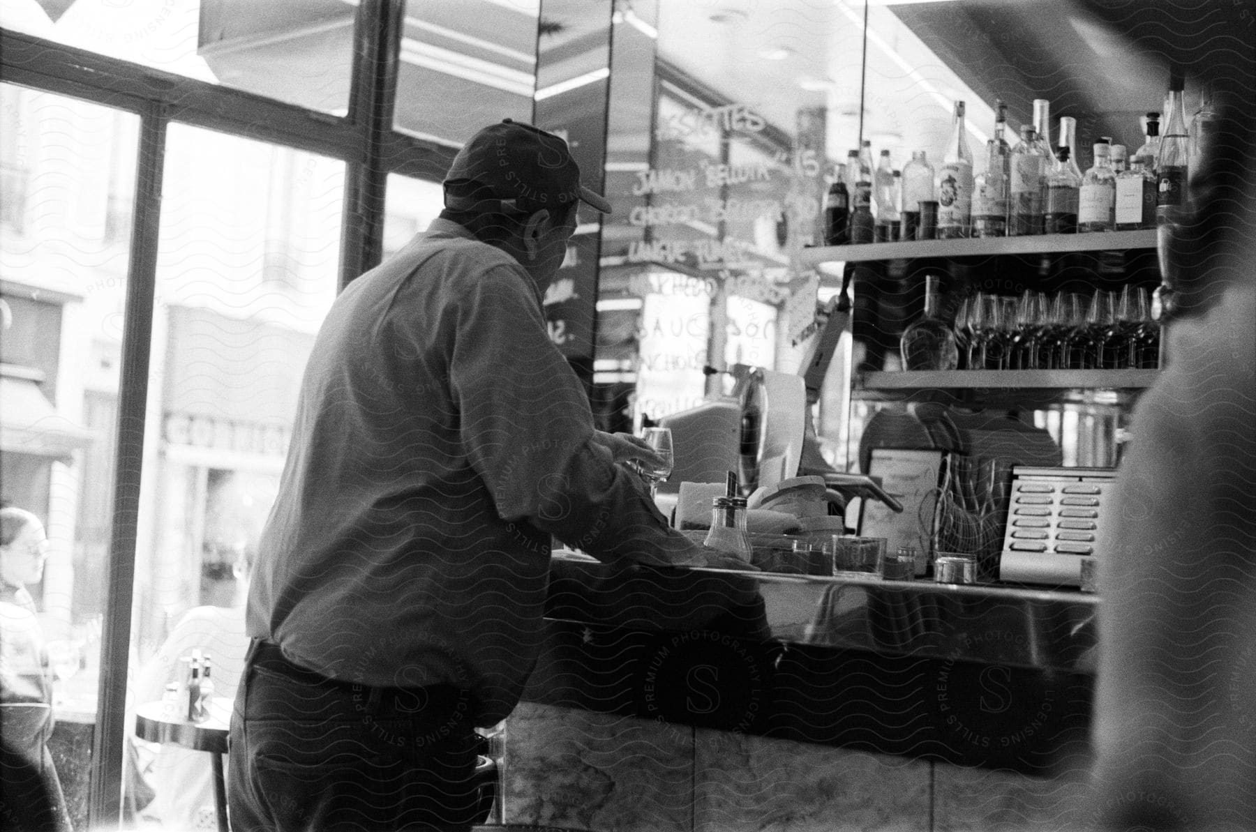 Man inside and at the counter of a bar.