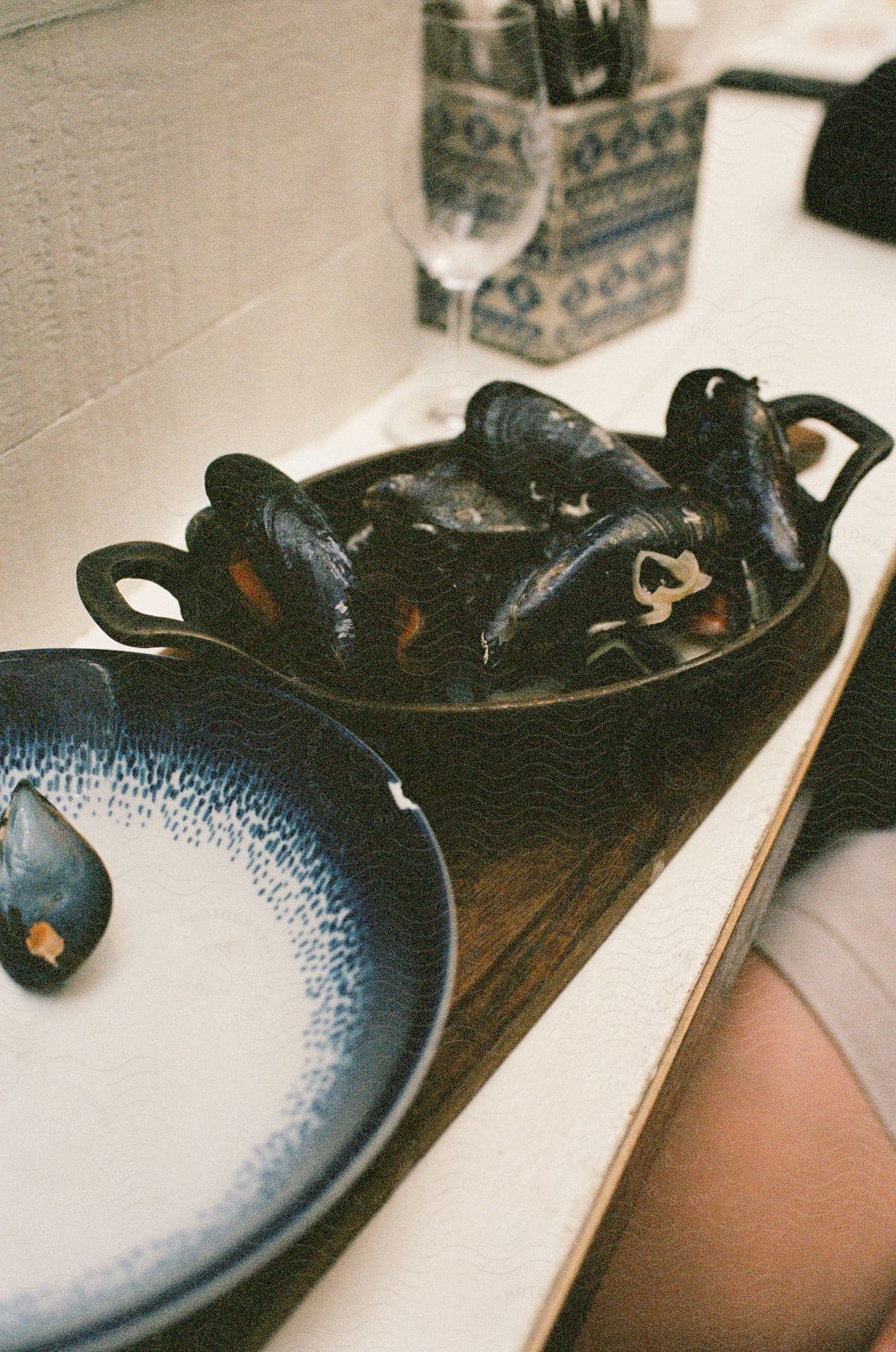 Bowl with oysters on a wooden board