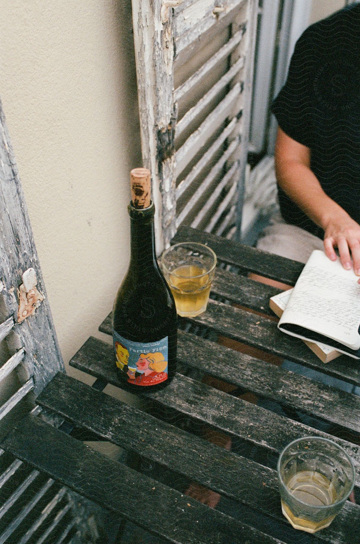 Wooden table with two glasses and a bottle of drinks