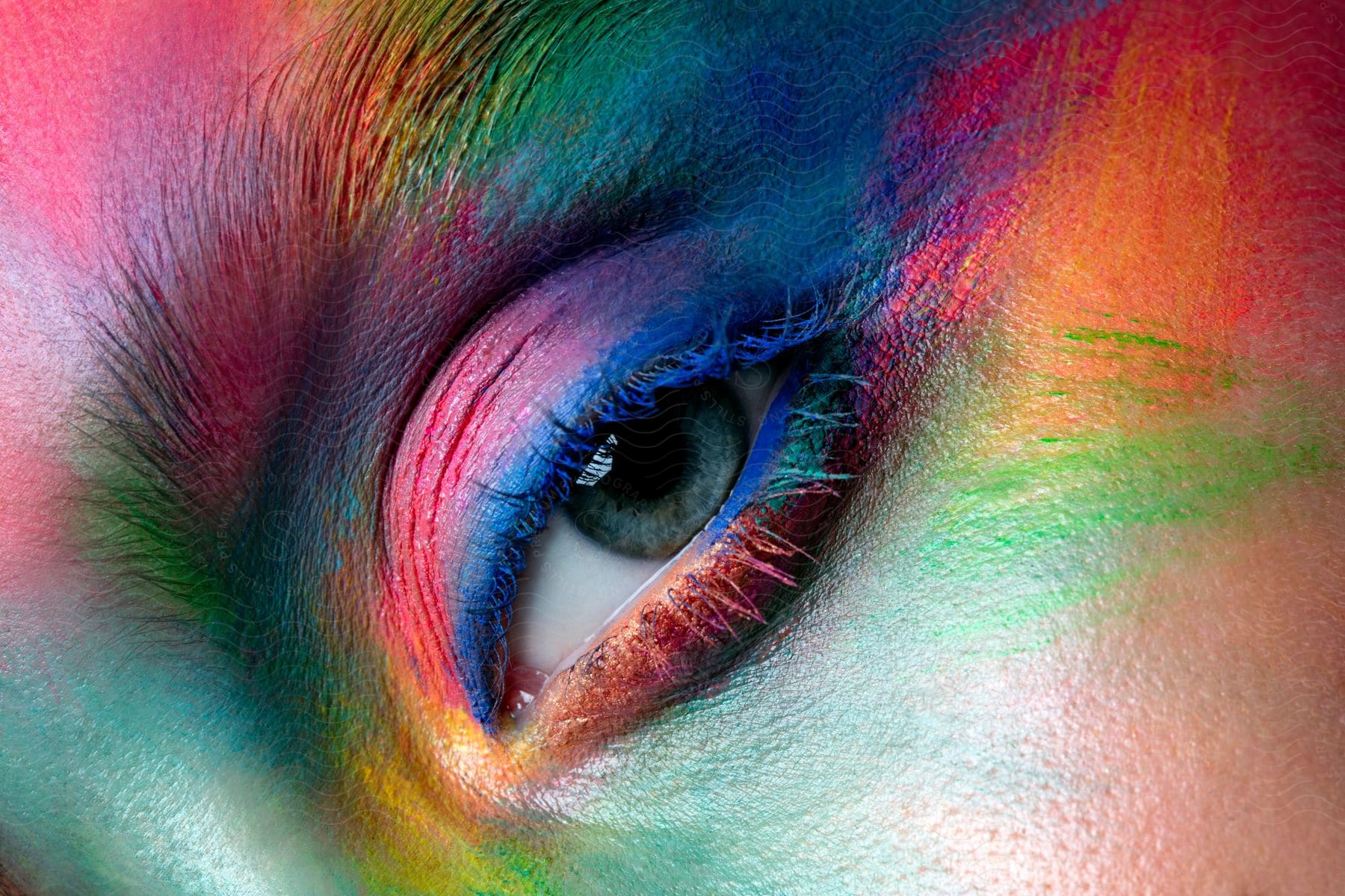 Close up of woman's eye with colorful face paint on