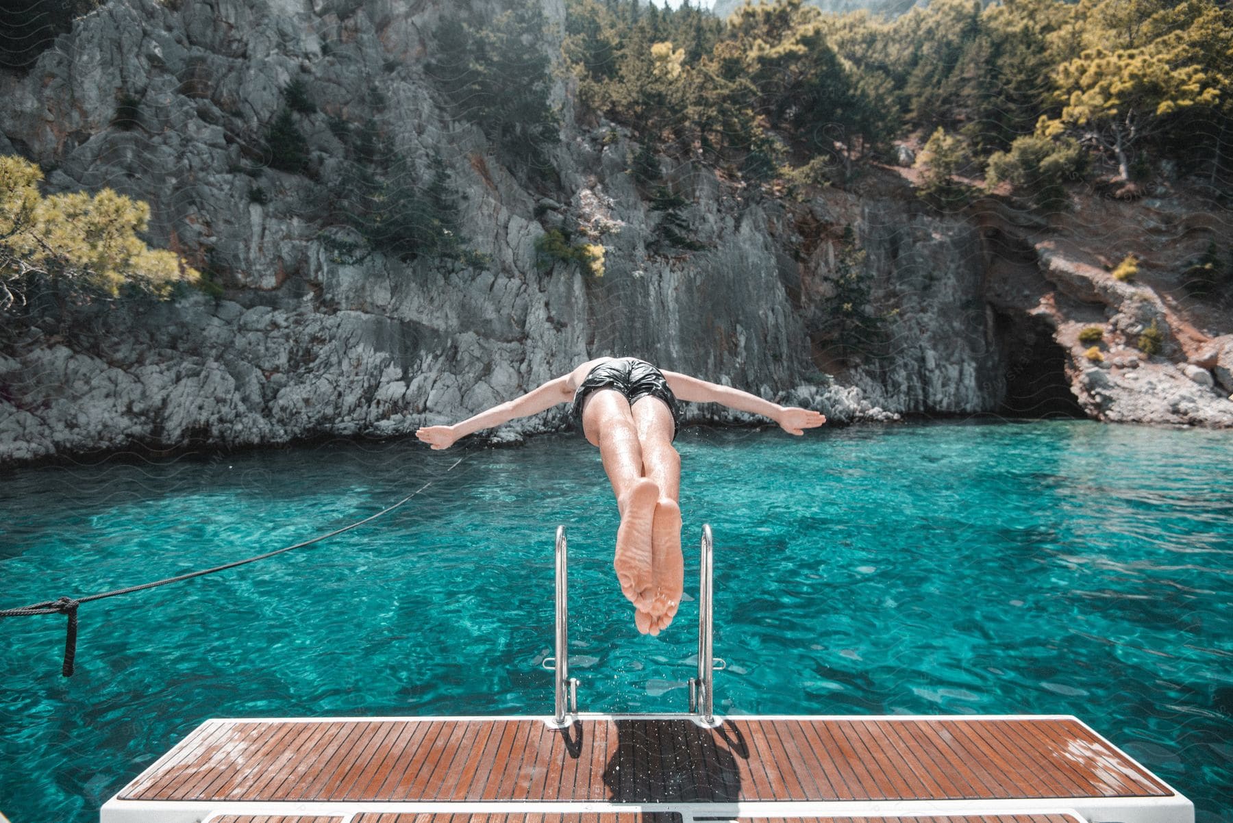 A man diving into a lake to swim