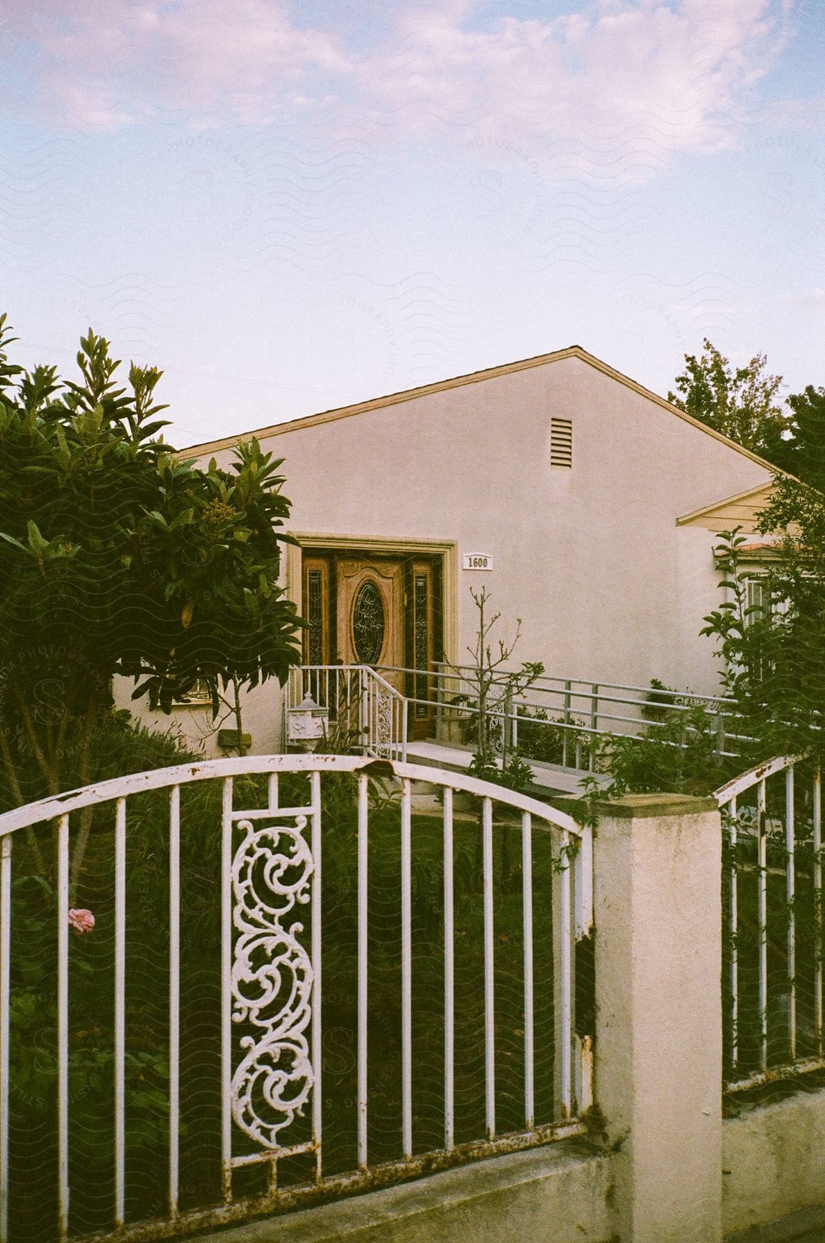 Gate with a house in the background and trees around