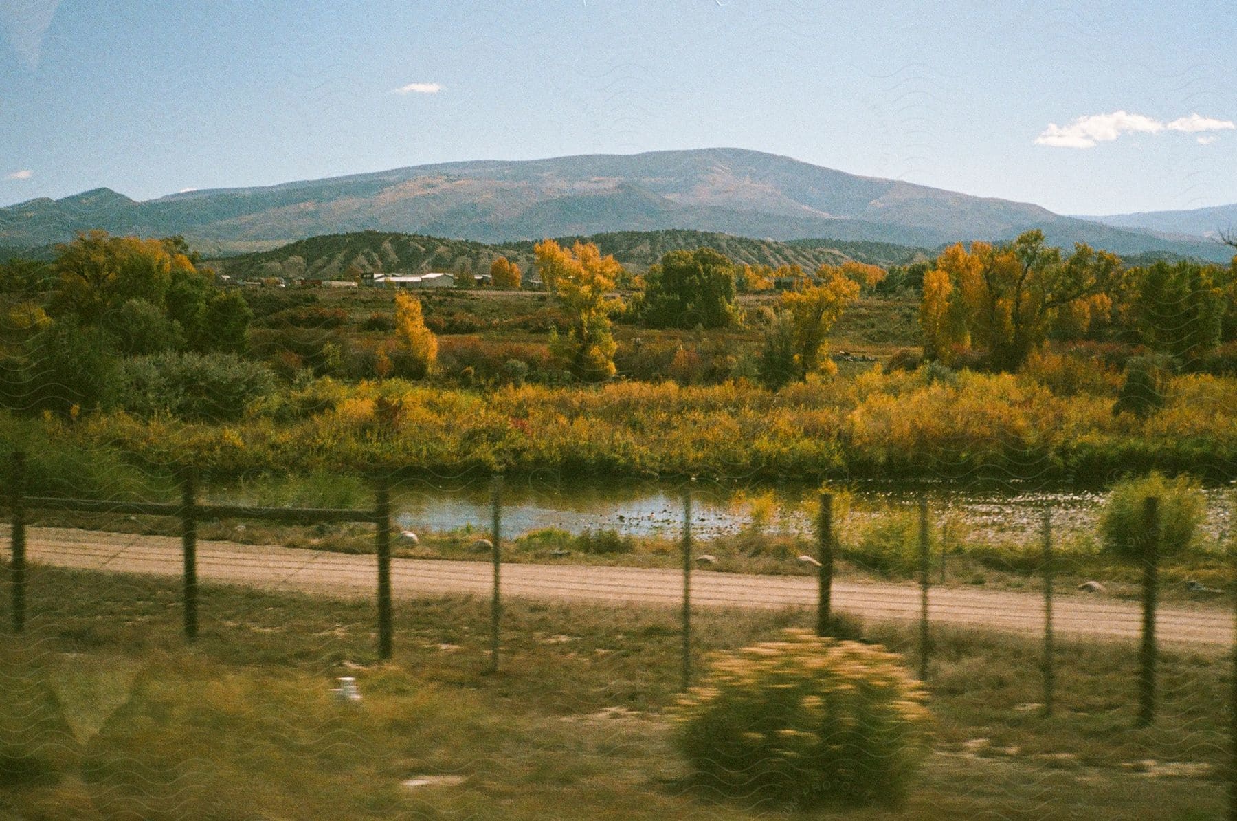 Natural landscape of a lake with hills and mountains on the horizon