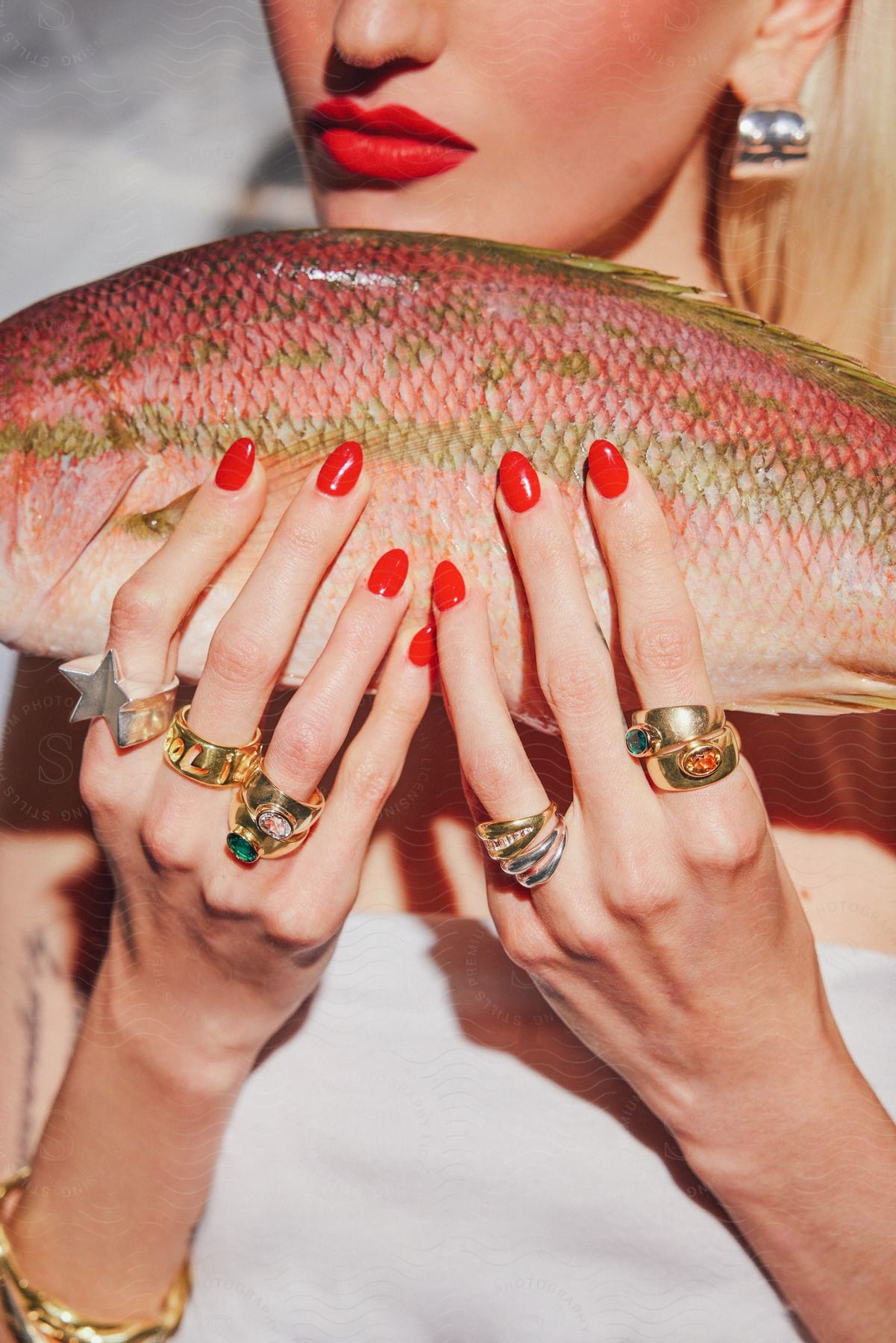 A Woman Holding A Fish In A Room