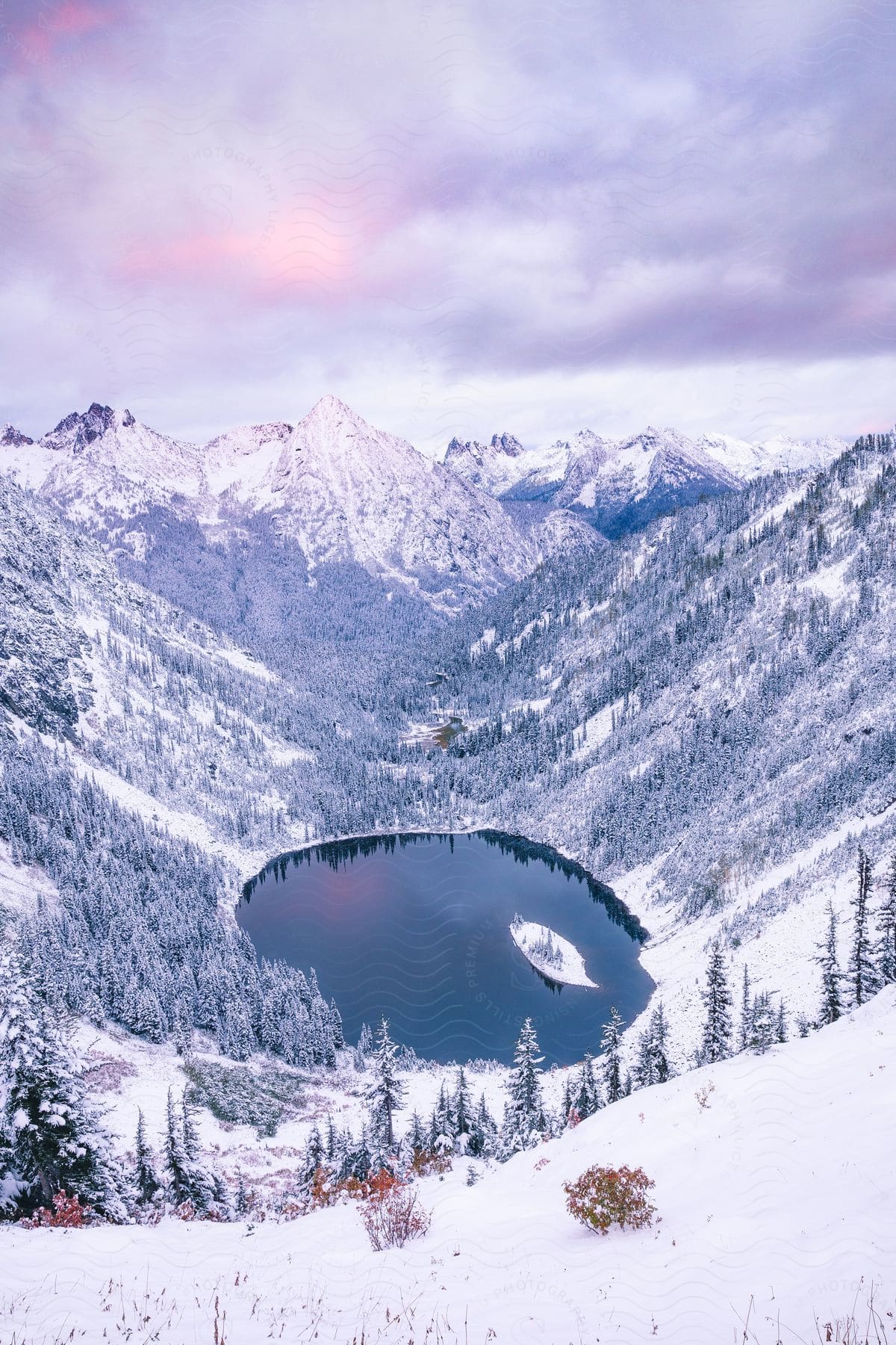 A lake in the center of a snowy mountain range.
