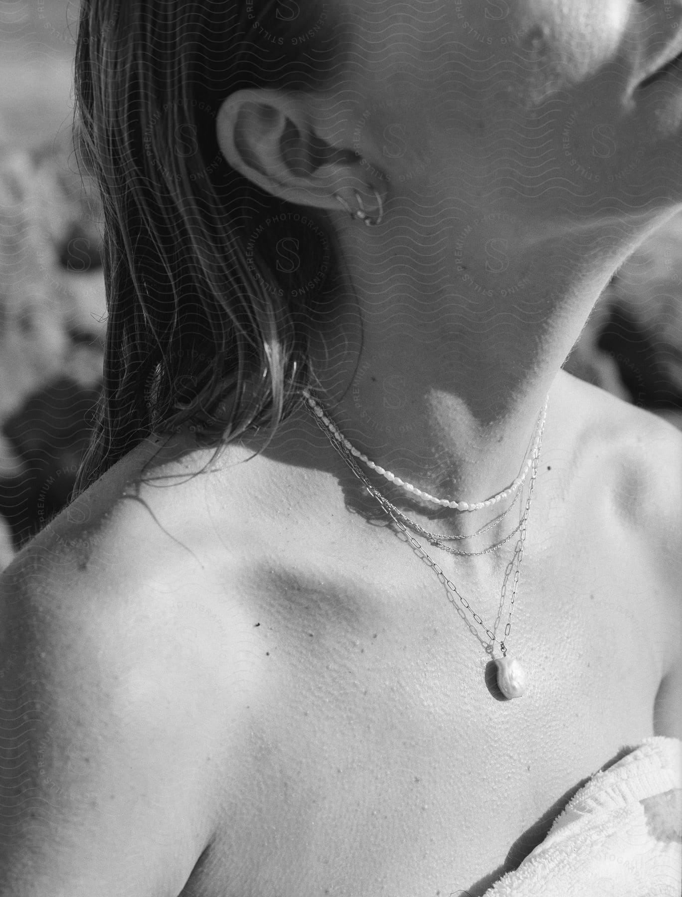 A woman modeling a necklace outdoors