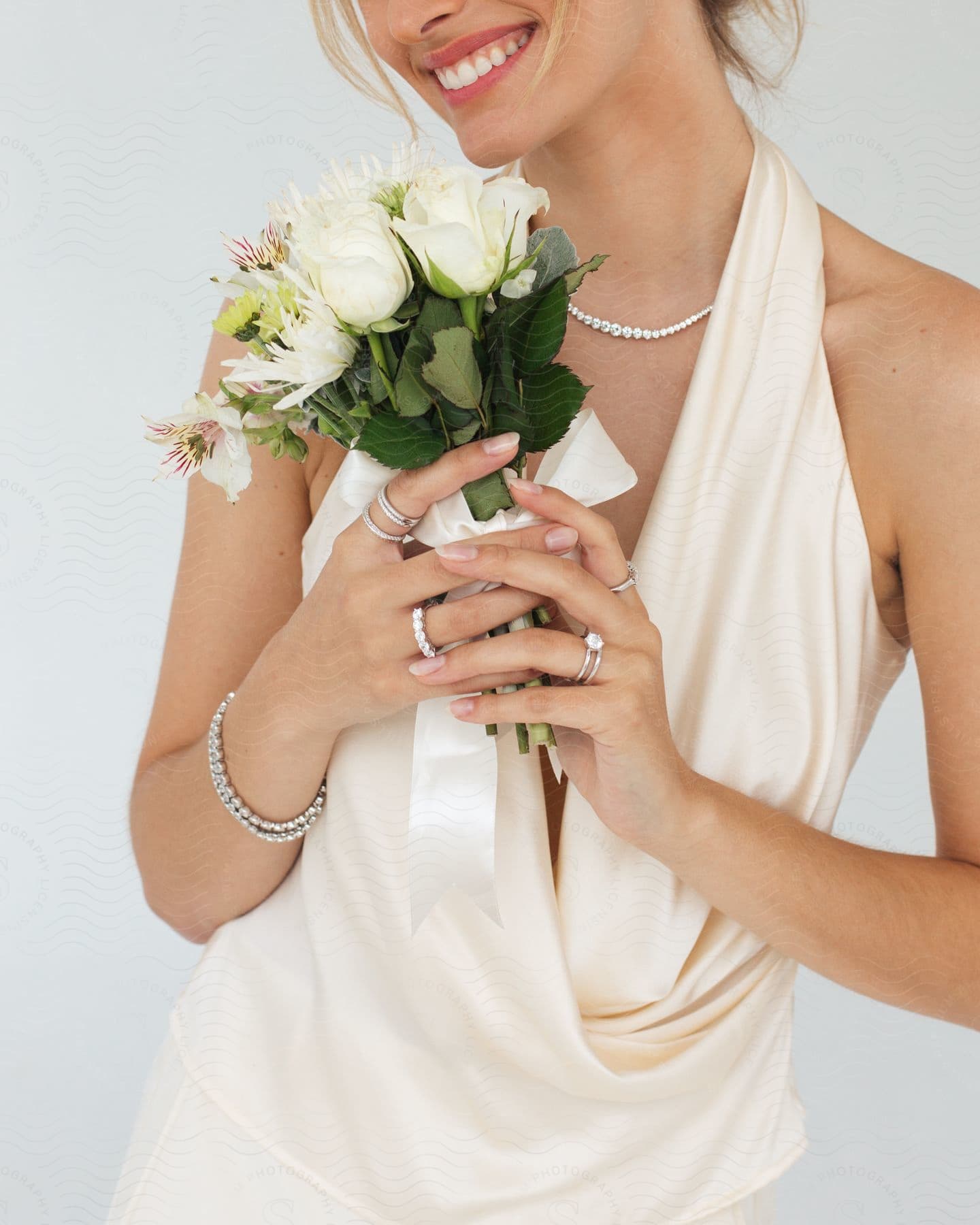 A smiling woman holds a bouquet of flowers