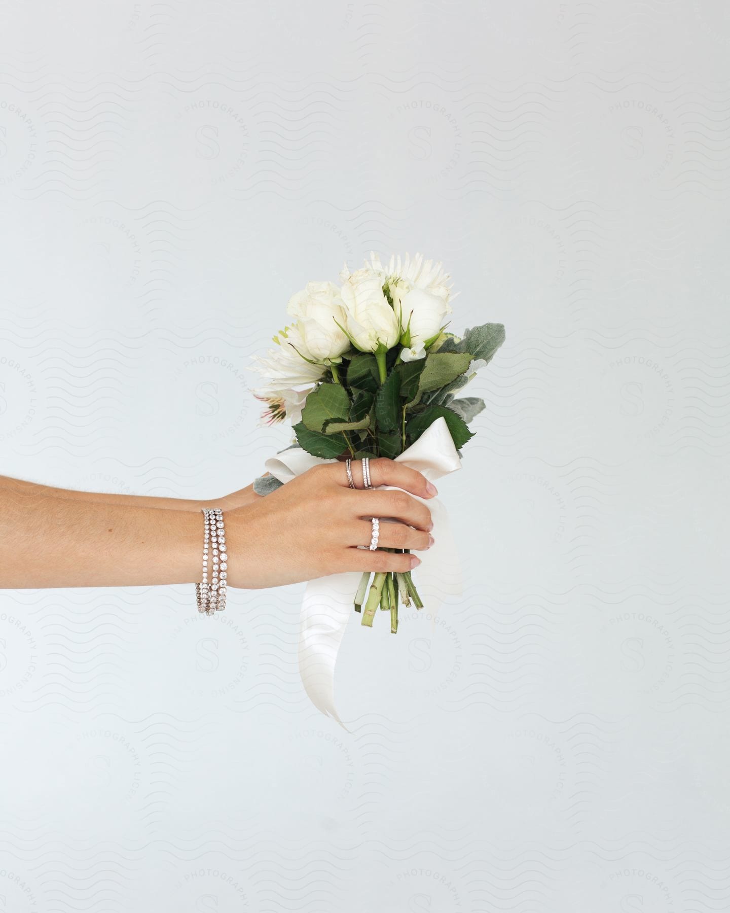 A wedding bouquet held by a woman's hands