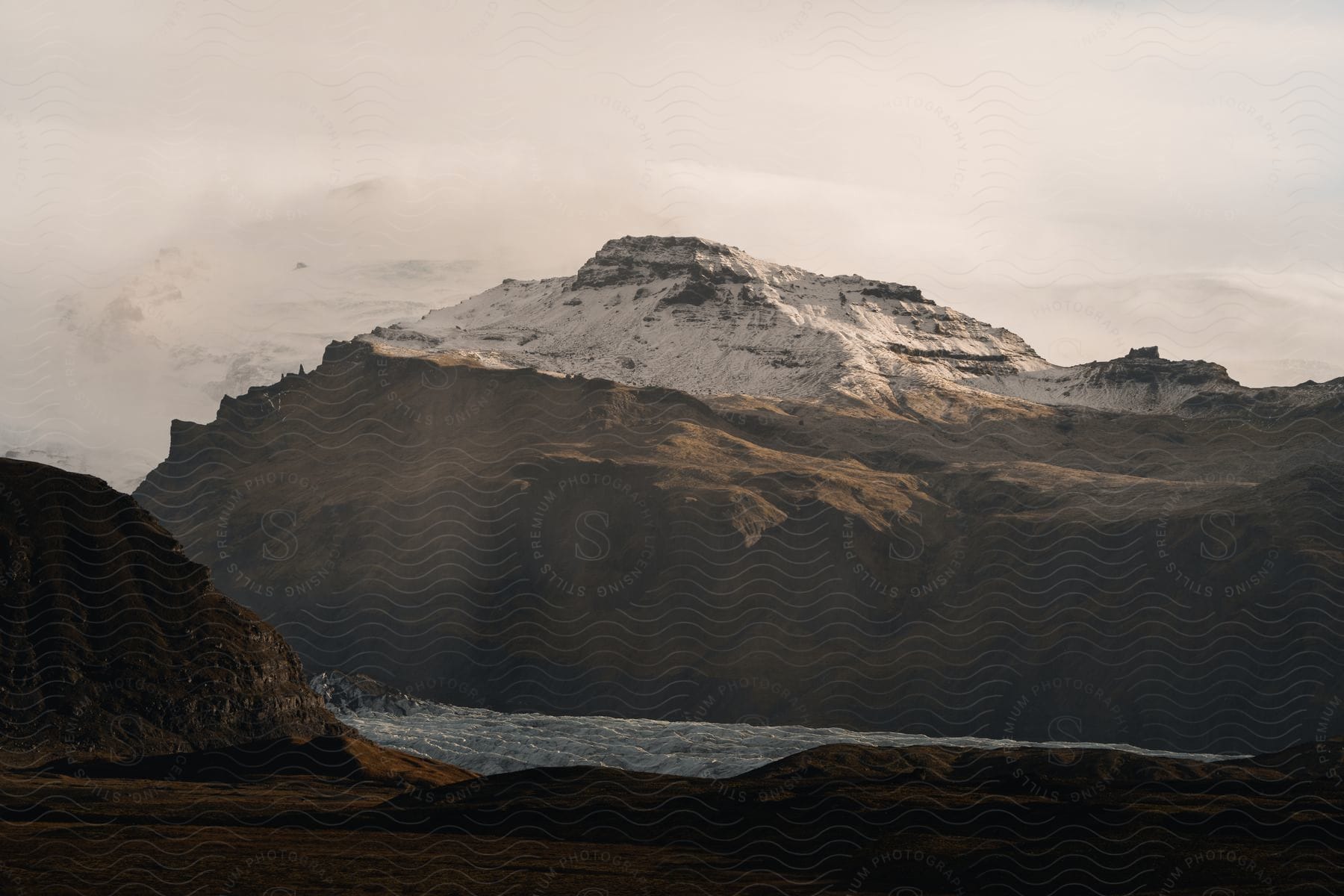 A snowy mountain peak rising above a glacier.