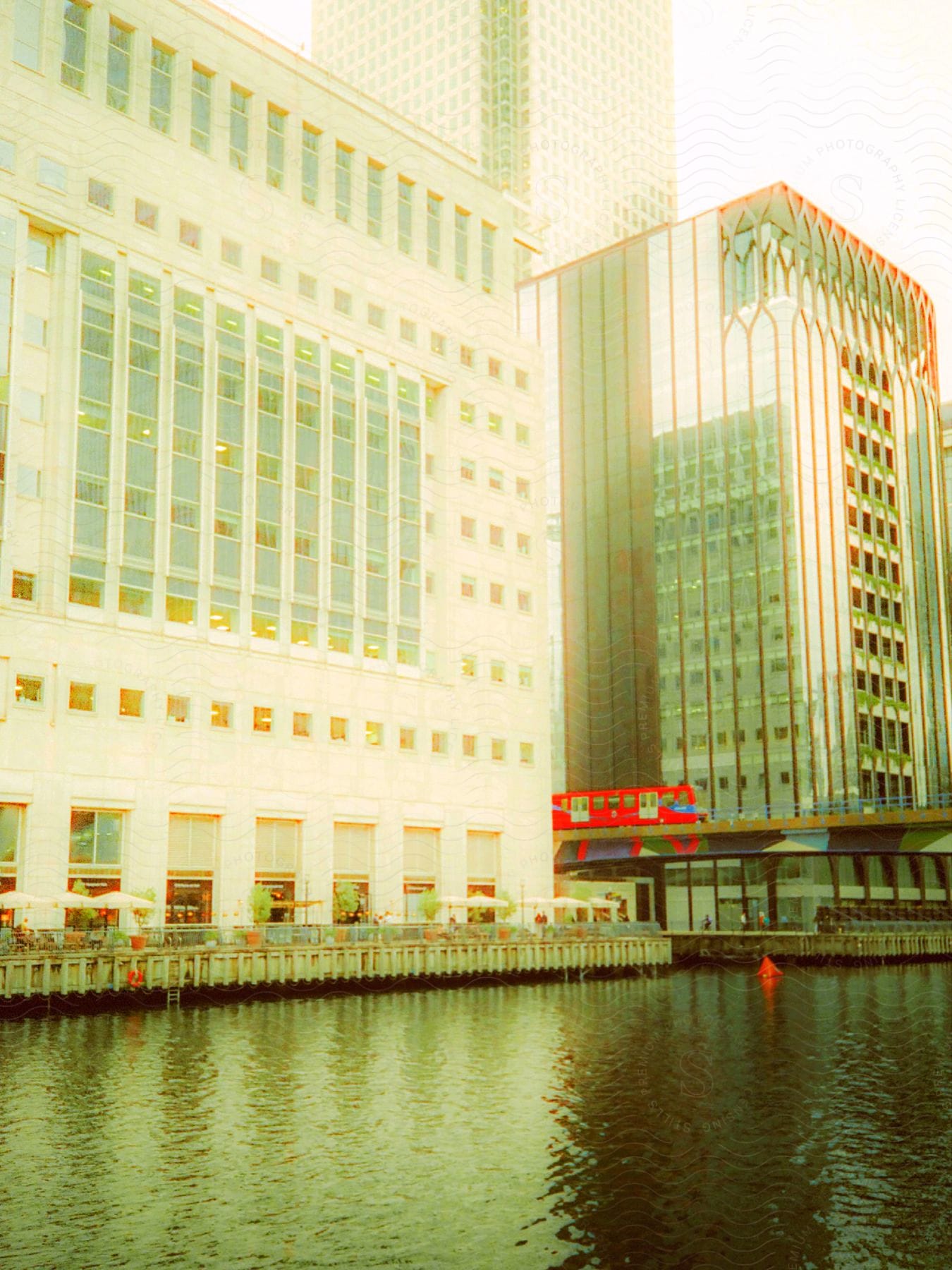 A train car on a track between two large buildings