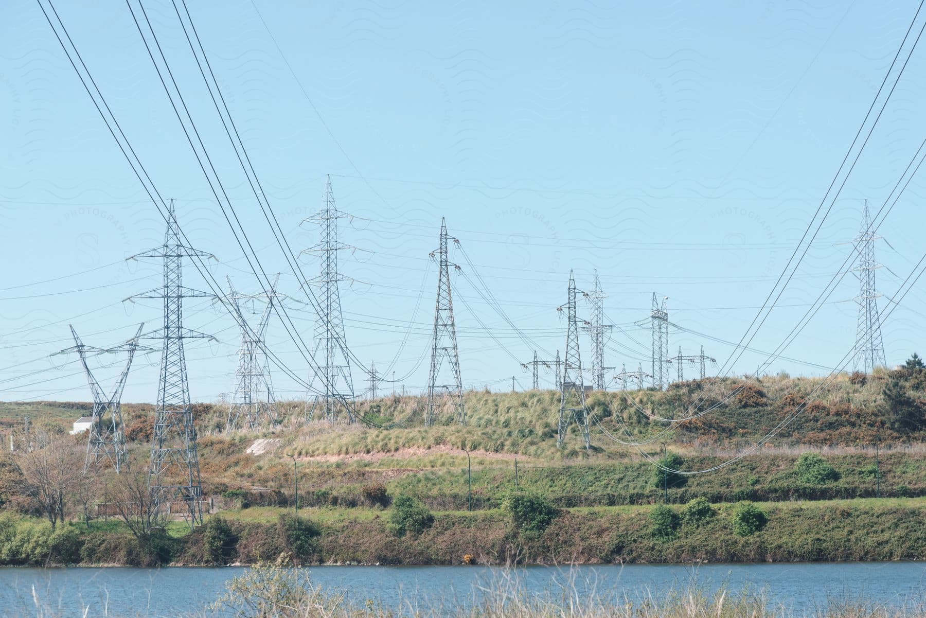 Electrical transmission towers stretching power lines over a river.