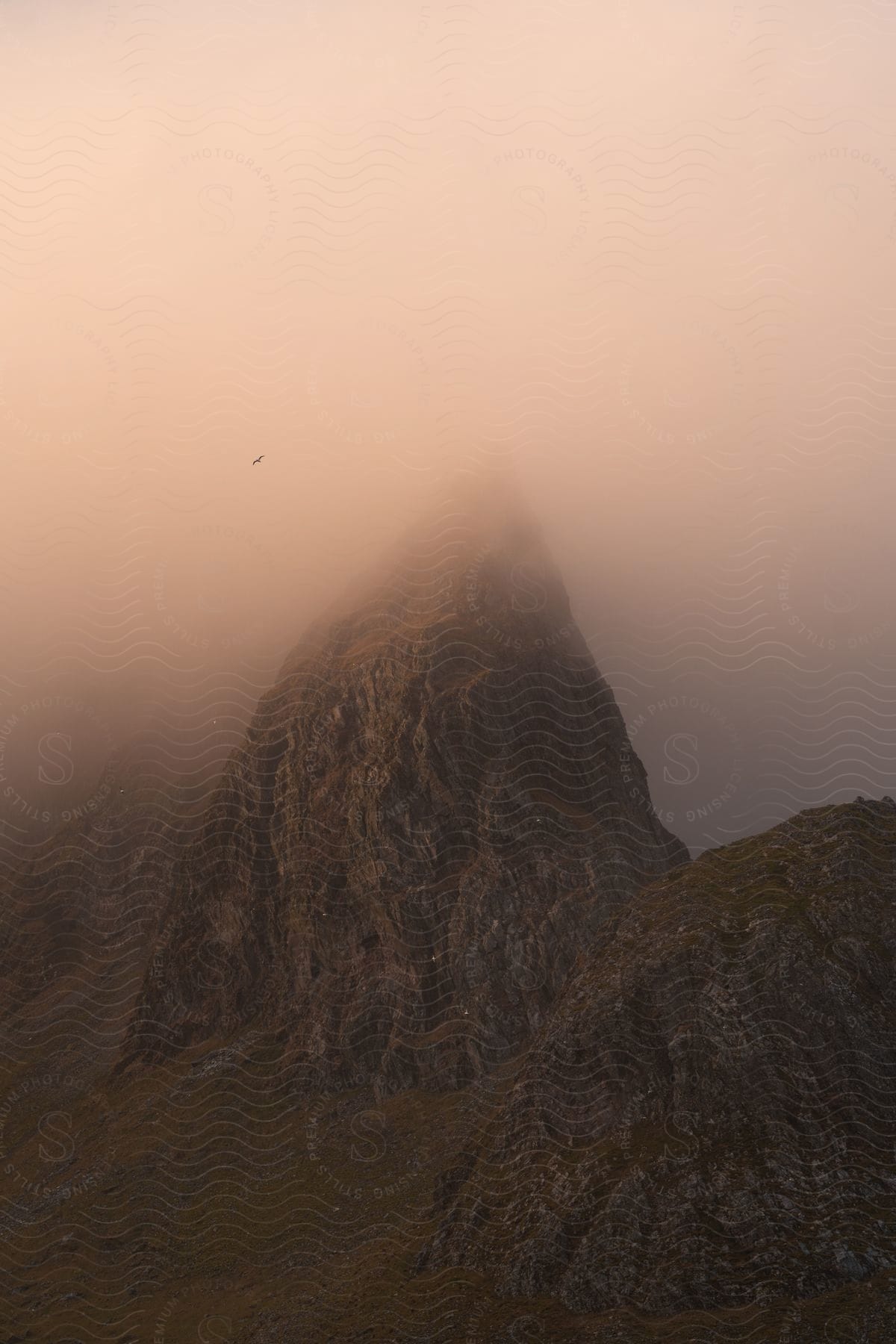 Mountains surrounded by heavy dense clouds.