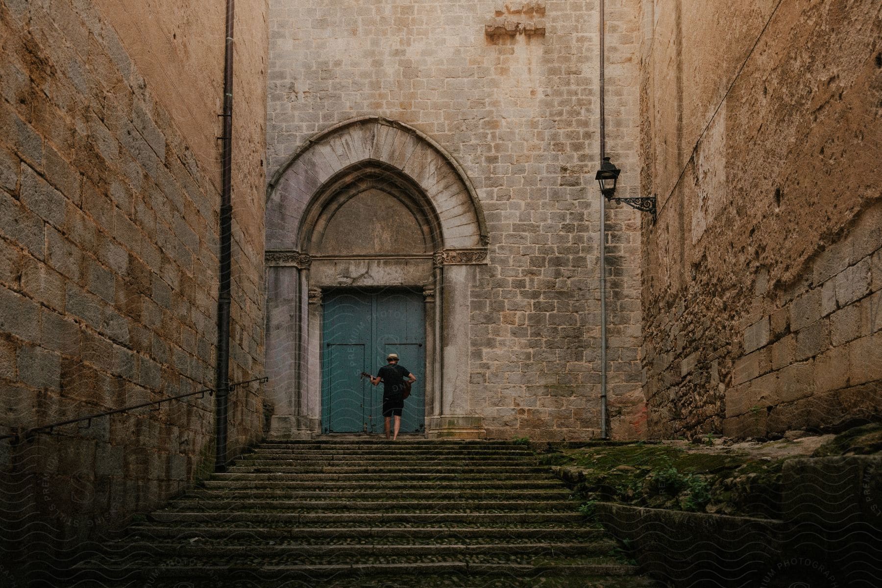 A man standing outside of an ancient brick building