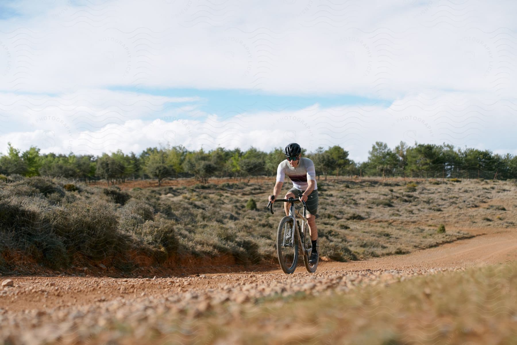 A man riding a bicycle outdoors on a trail