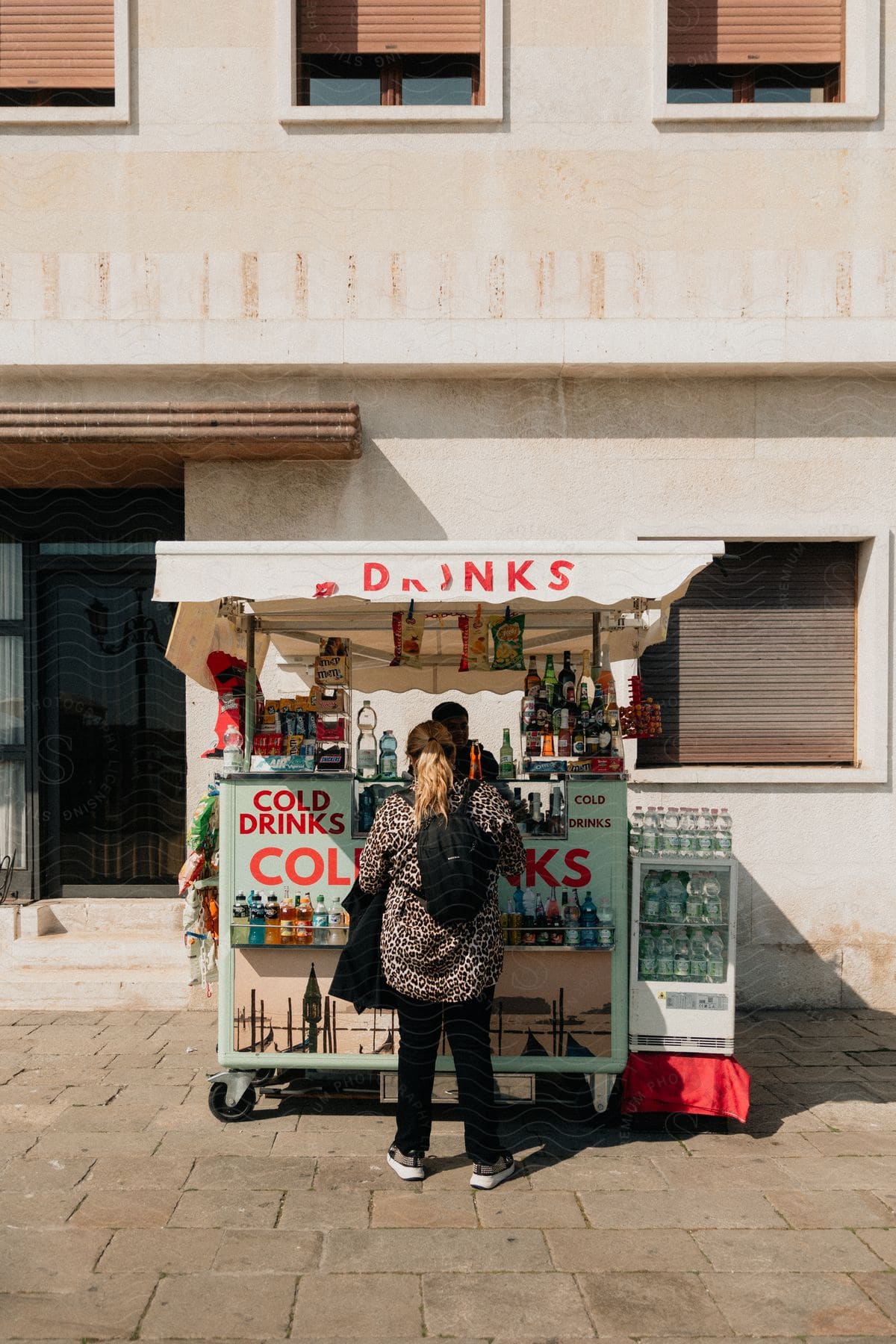 Woman in a drinks food truck on the sidewalk of a city