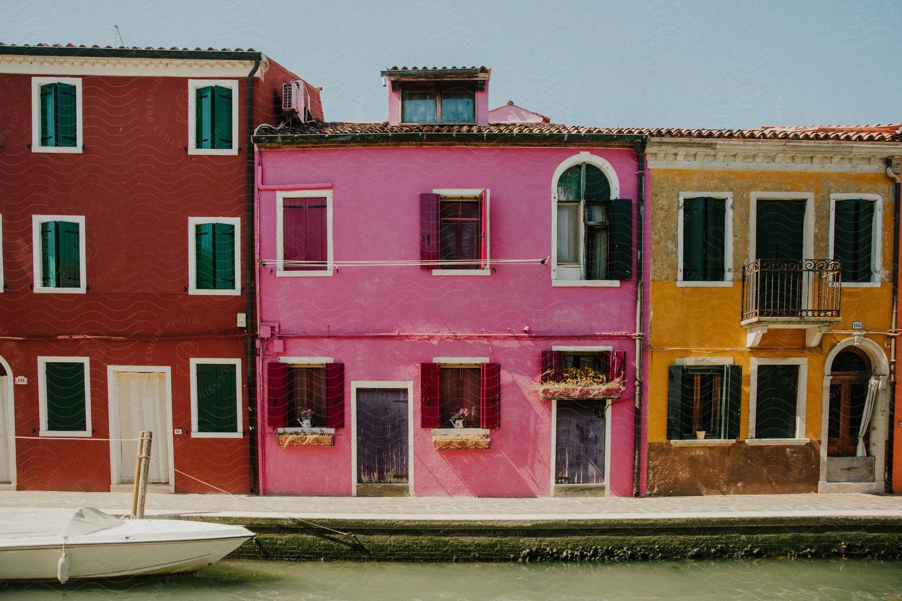 Colorful apartment buildings along the coast with a boat in the water