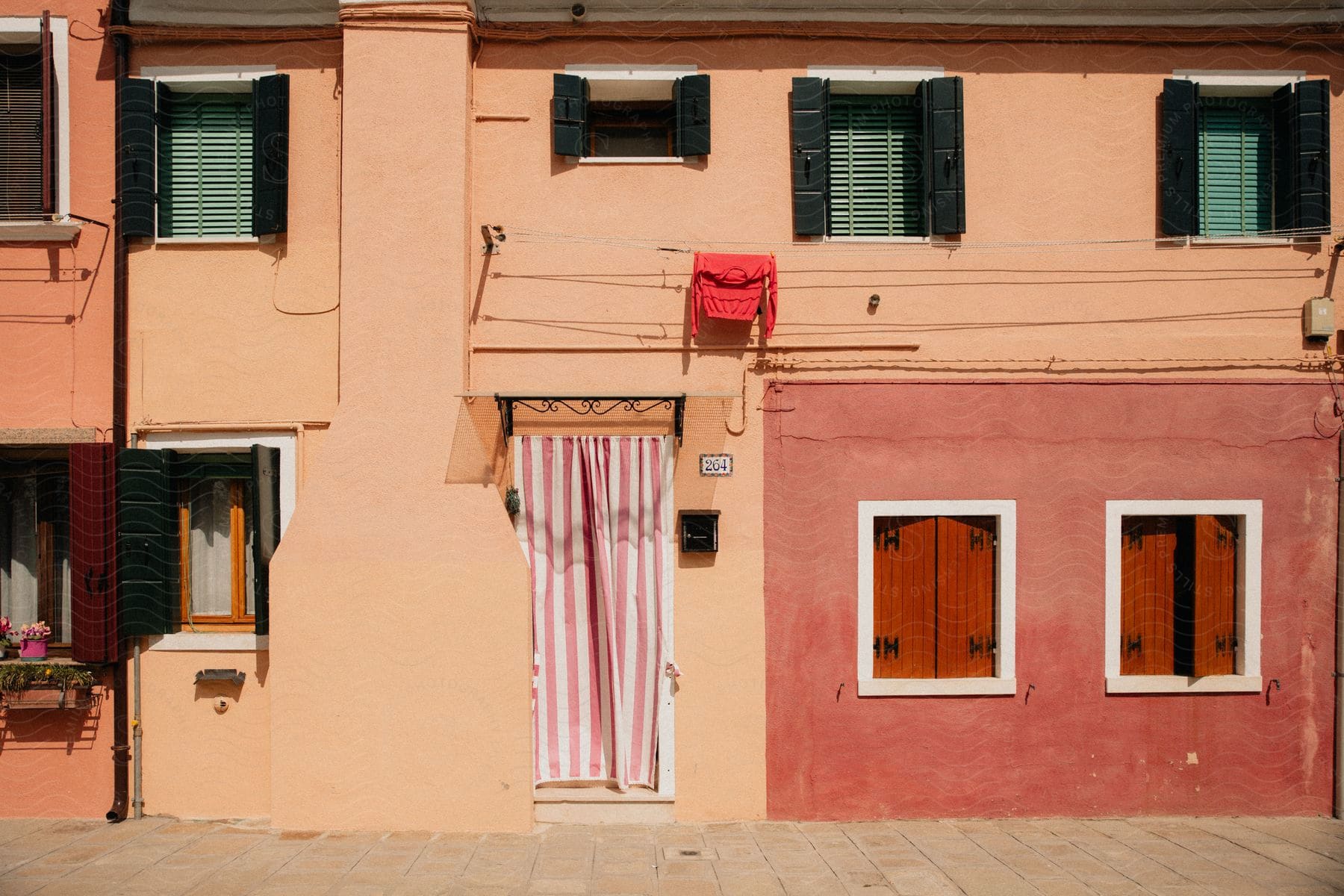 Striped door cover on front façade of orange building