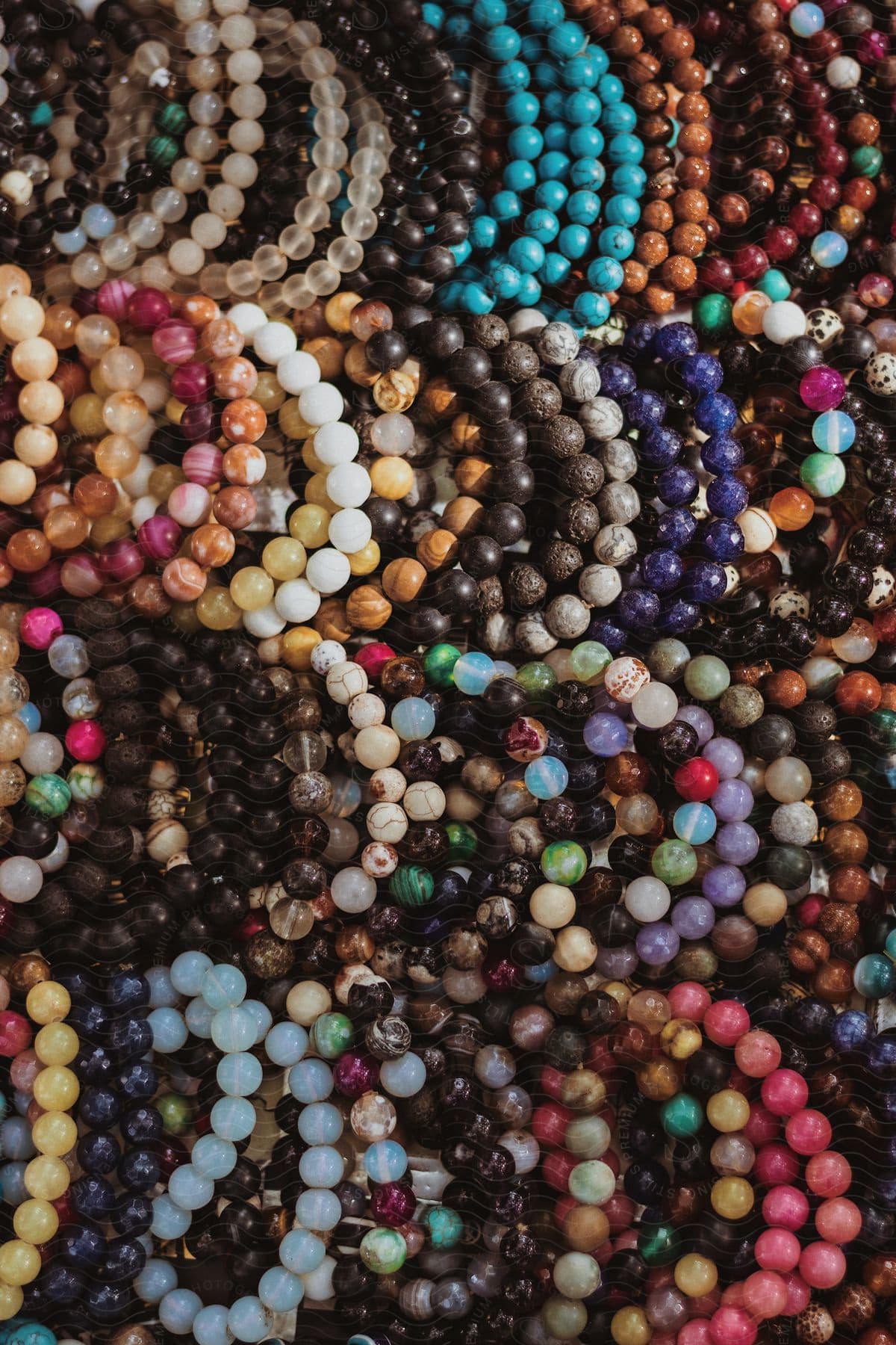 Close-up of various colored stone bracelets