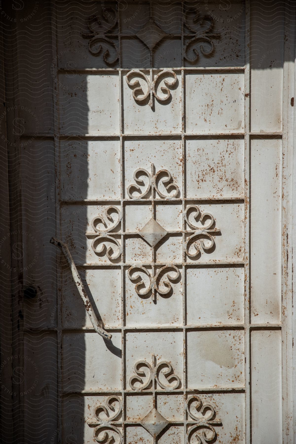 A metal door with decorative detail and a simple metal handle