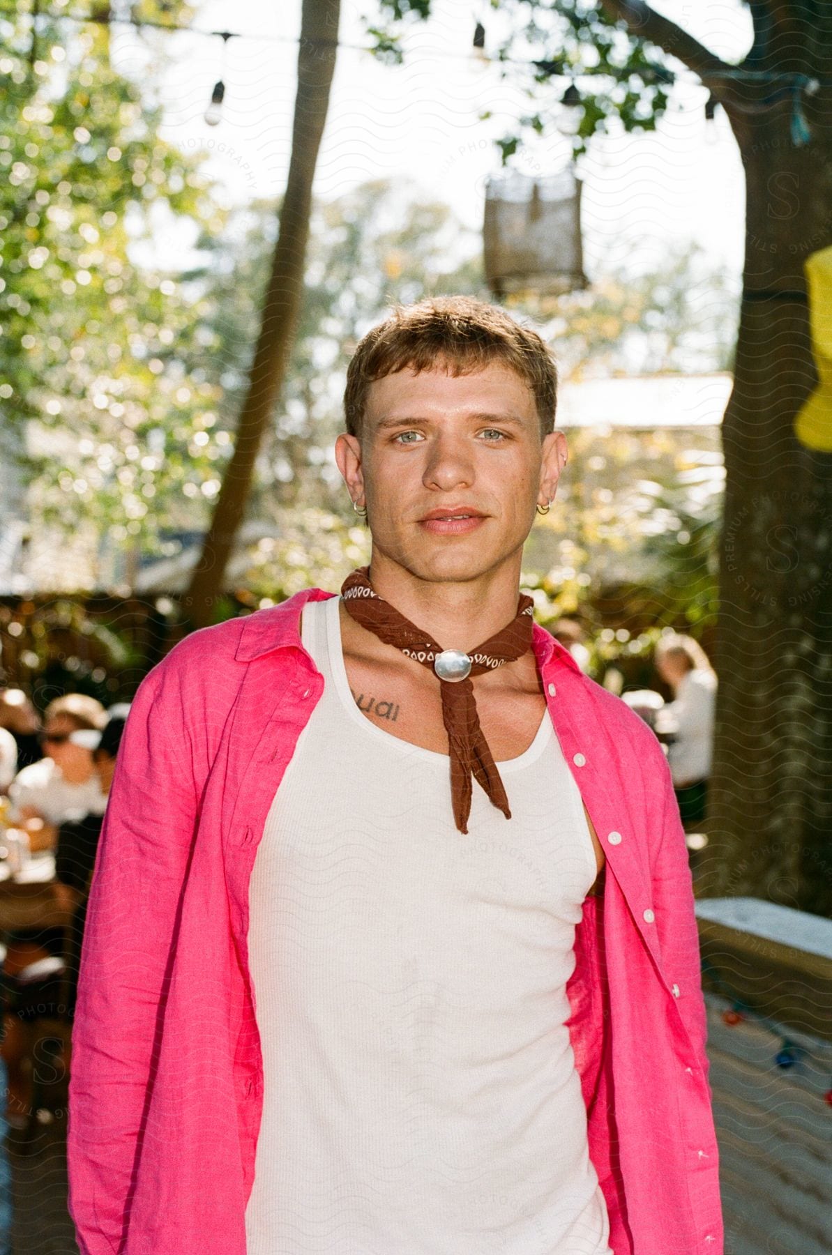 A portrait shot of a male model in a pink shirt